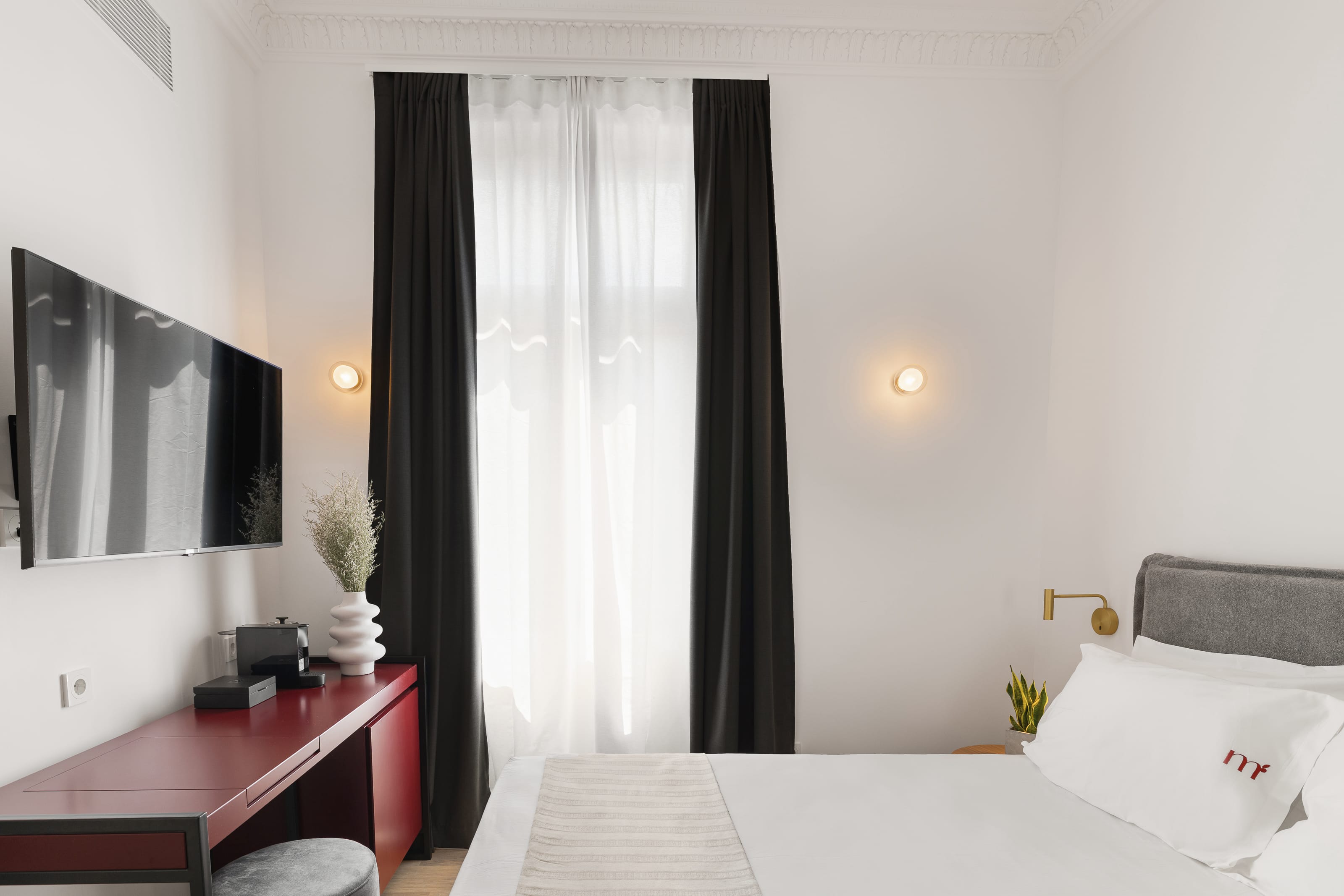 a bedroom with a bed and a desk