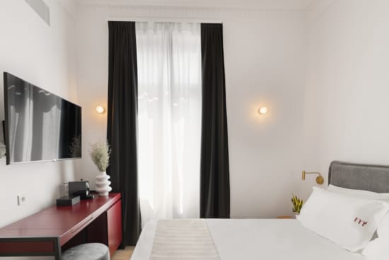 a bedroom with a bed and a desk