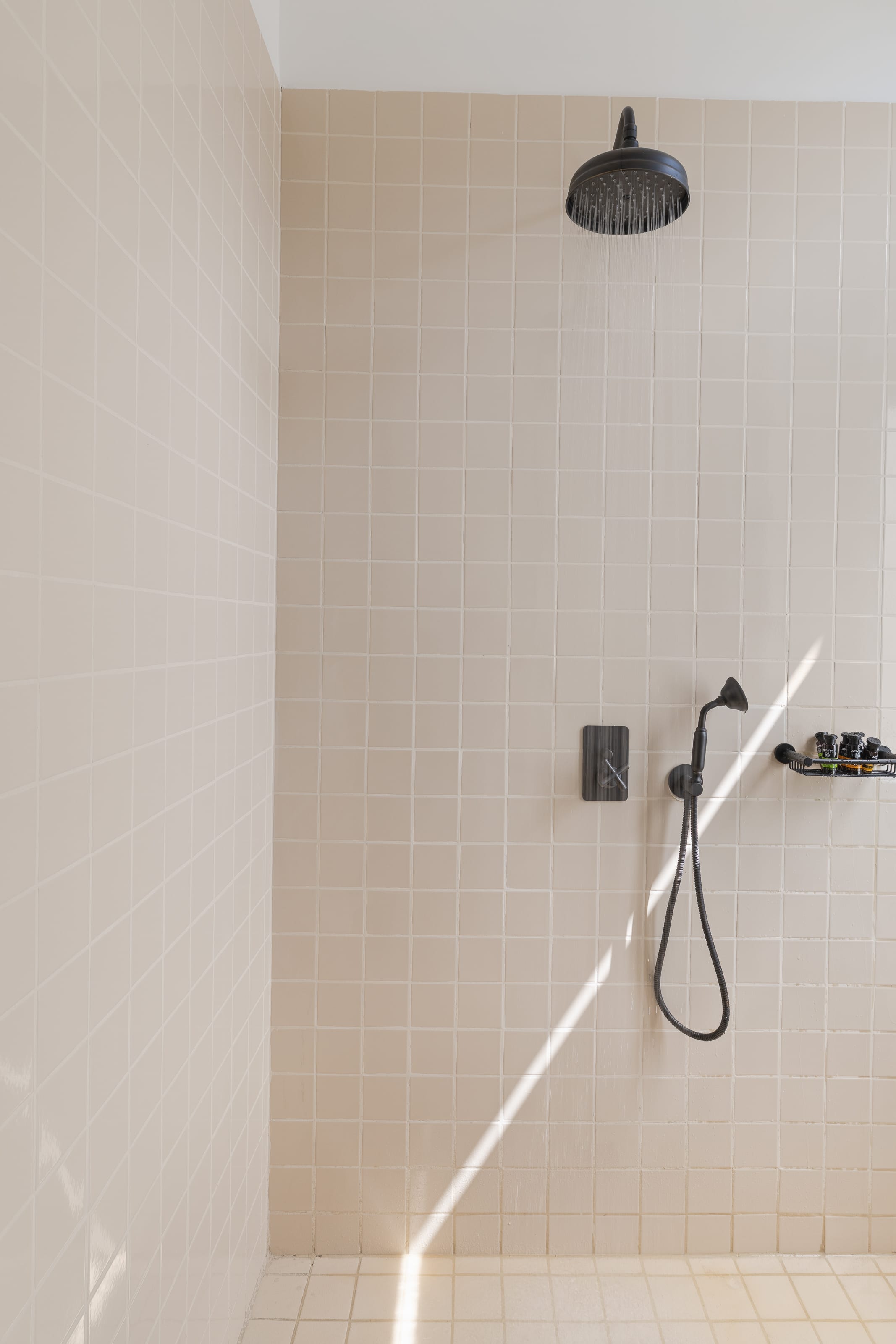 a shower with a black lamp