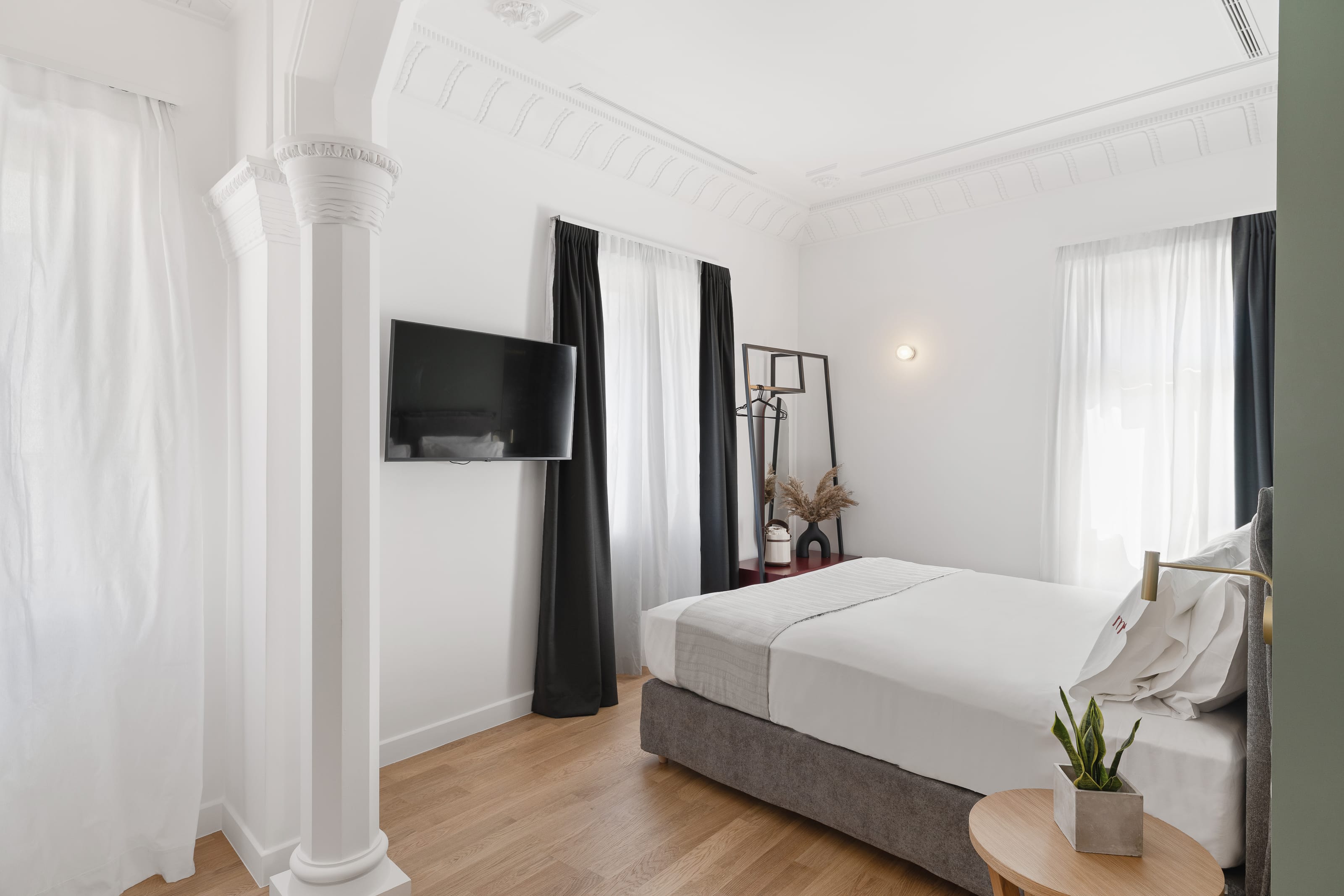 a room with a bed and a tv