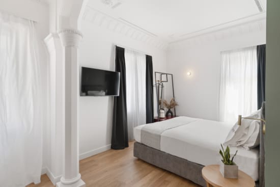 a room with a bed and a tv