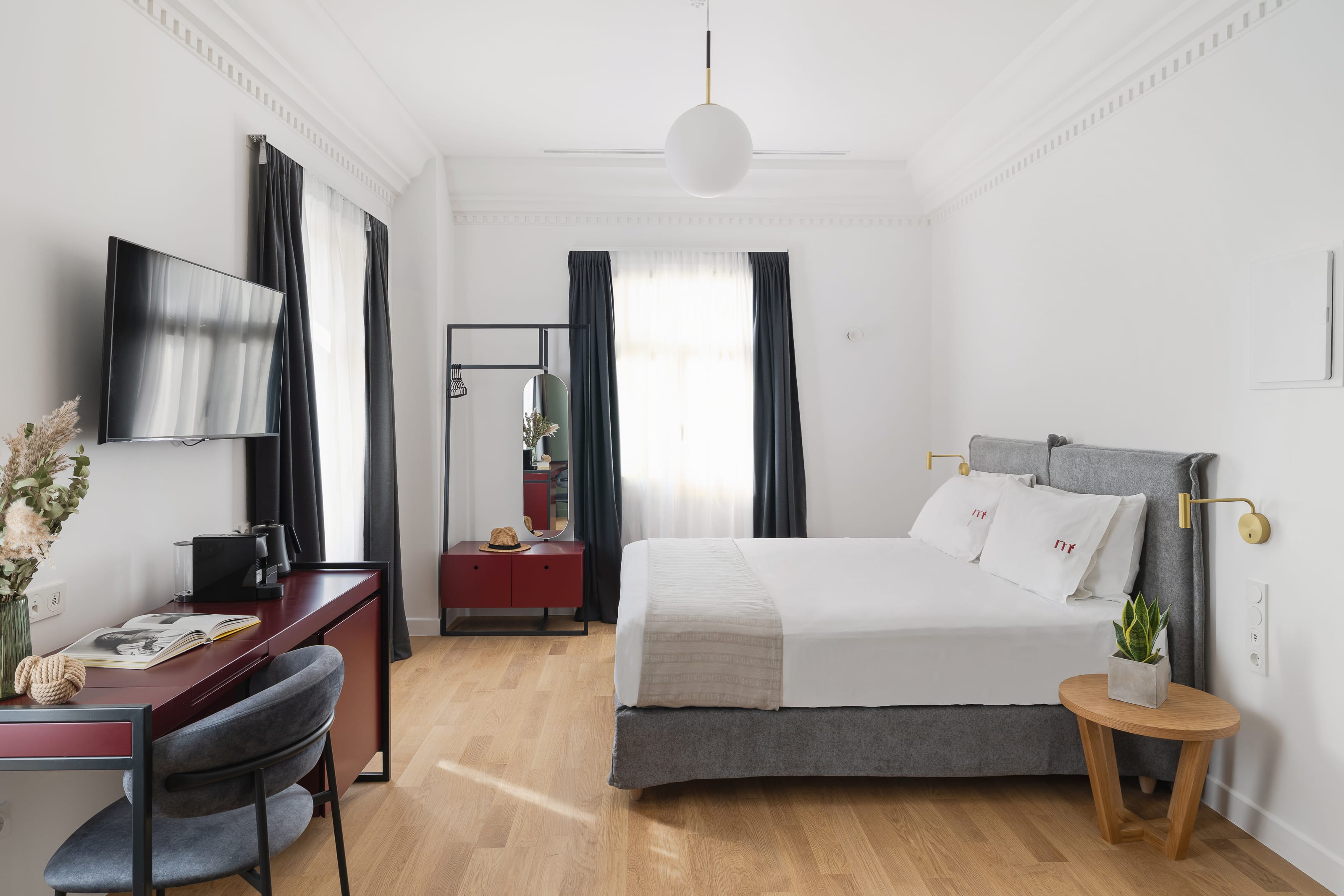 a bedroom with a bed desk and a mirror