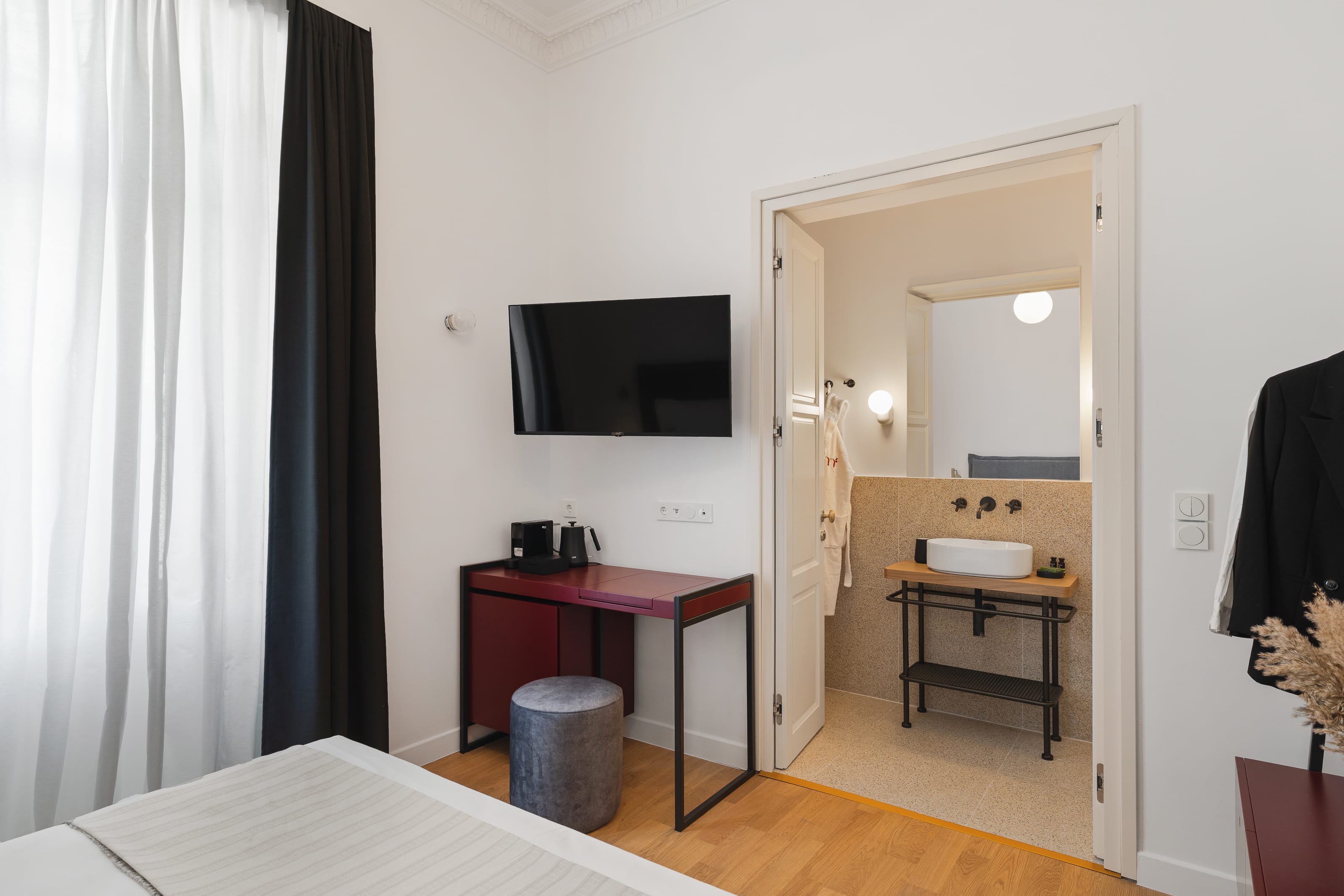 a room with a desk and a tv