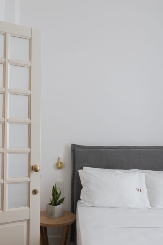 a white bed with a white door