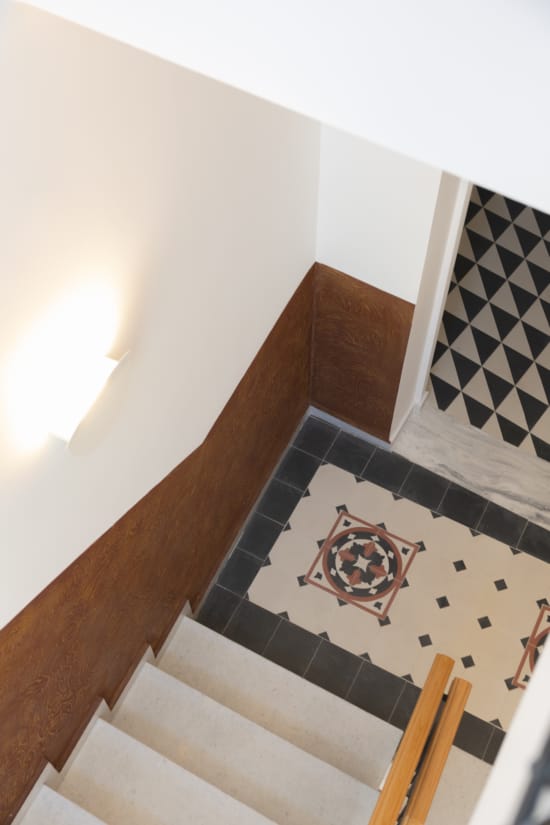 a staircase with a tile wall