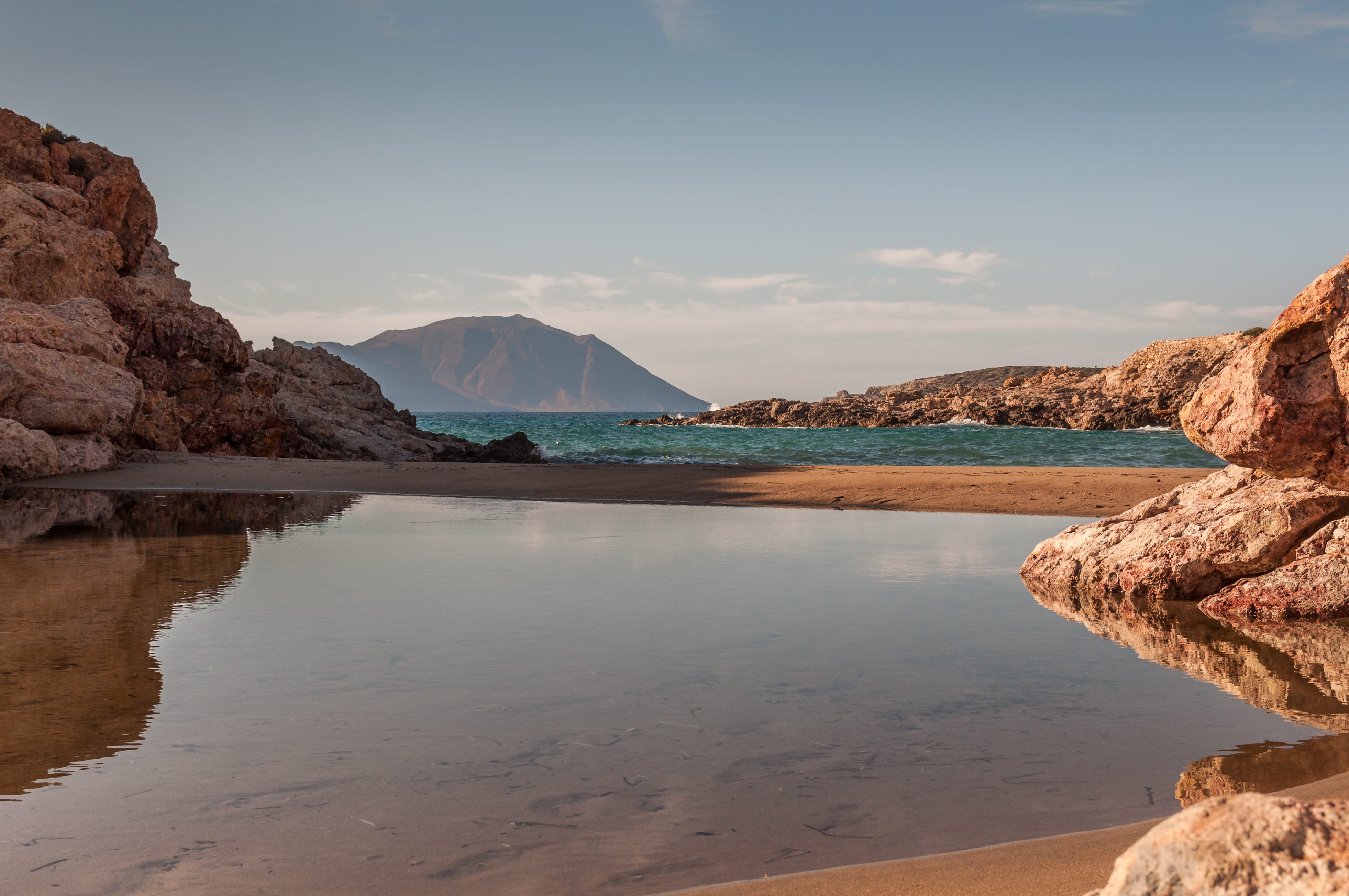 a body of water with a mountain in the background