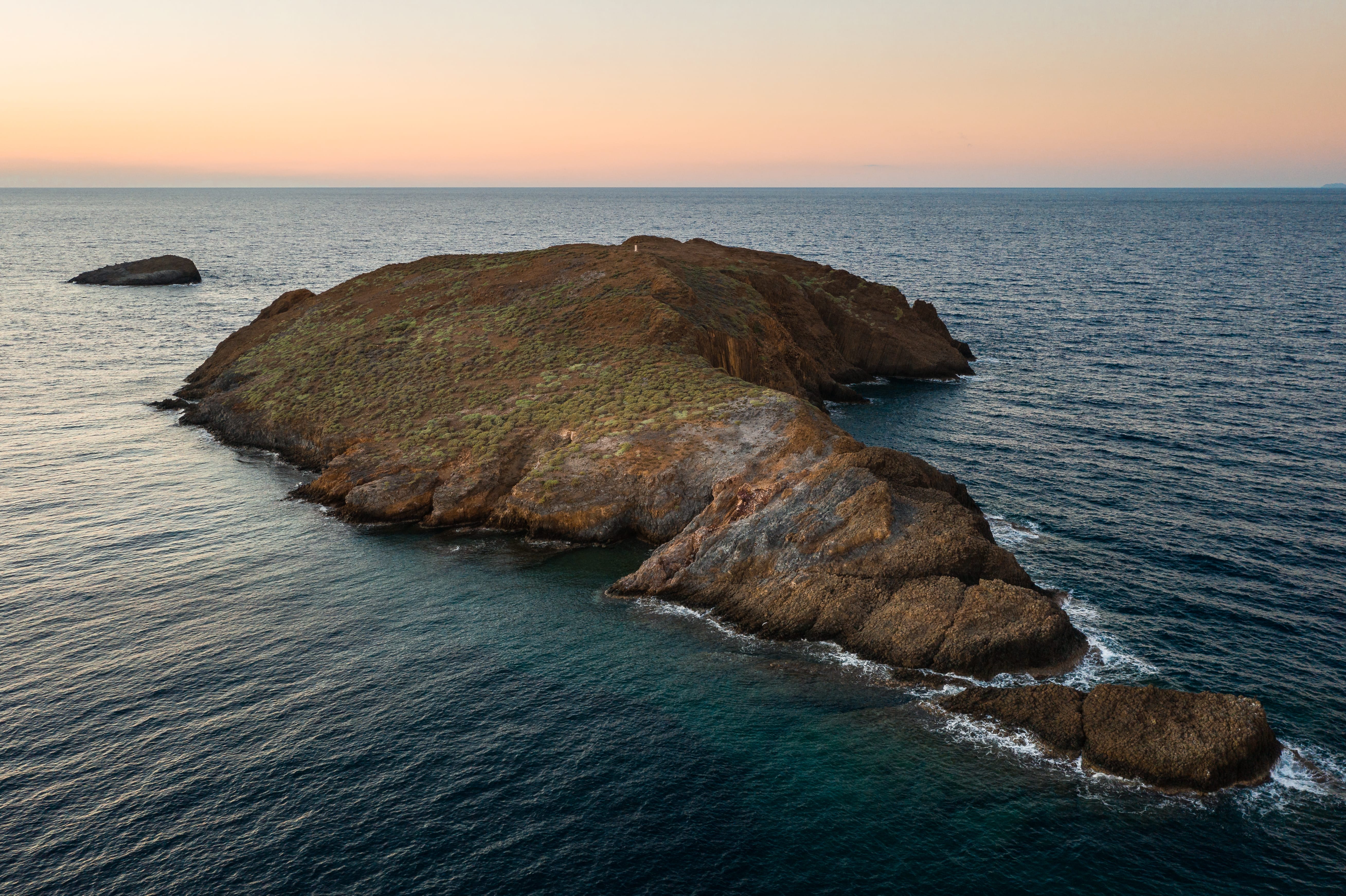 a group of large rocks in the ocean