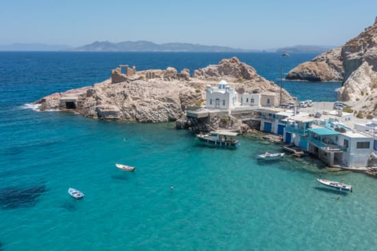 a group of buildings on a rocky island