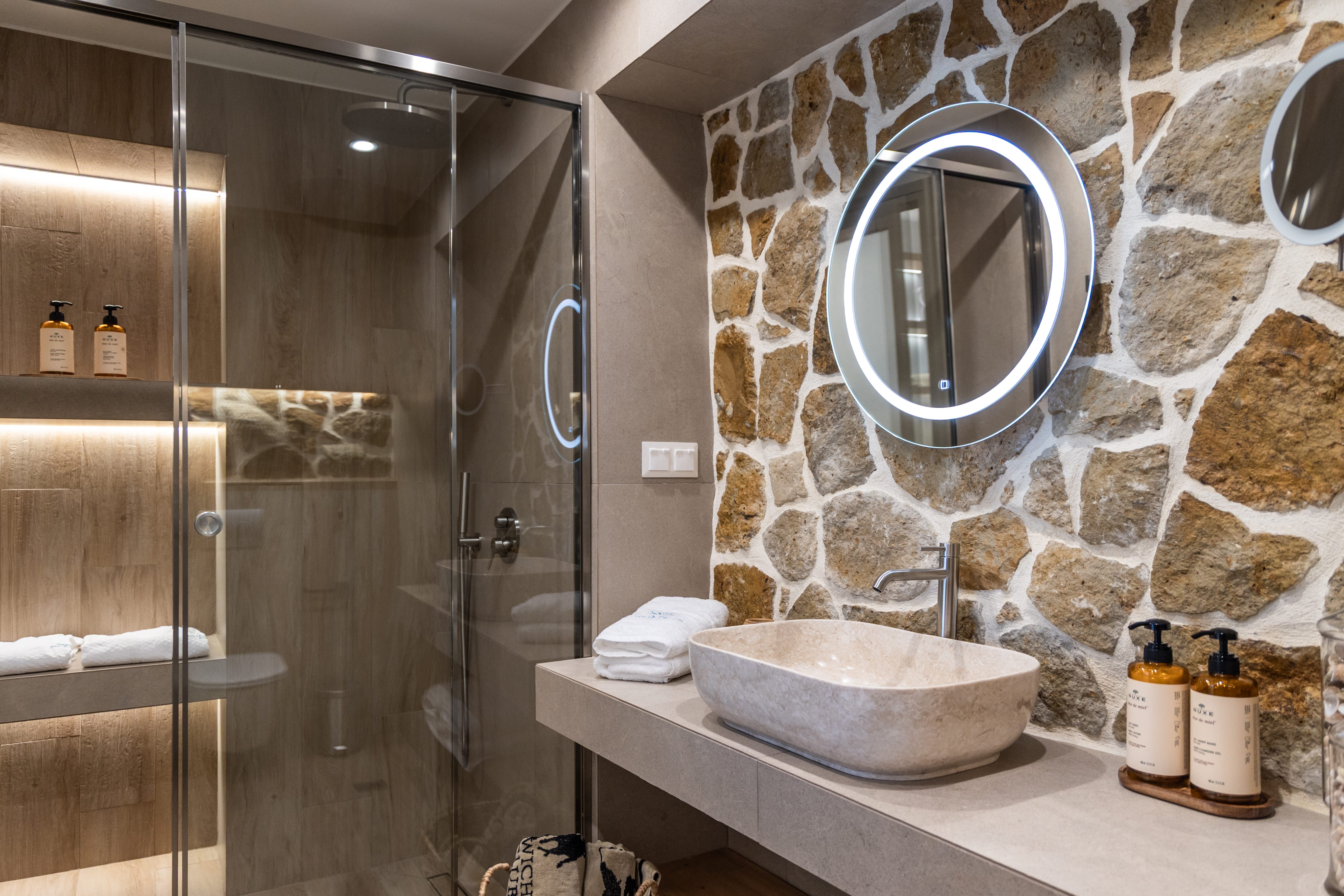 a bathroom with a stone wall