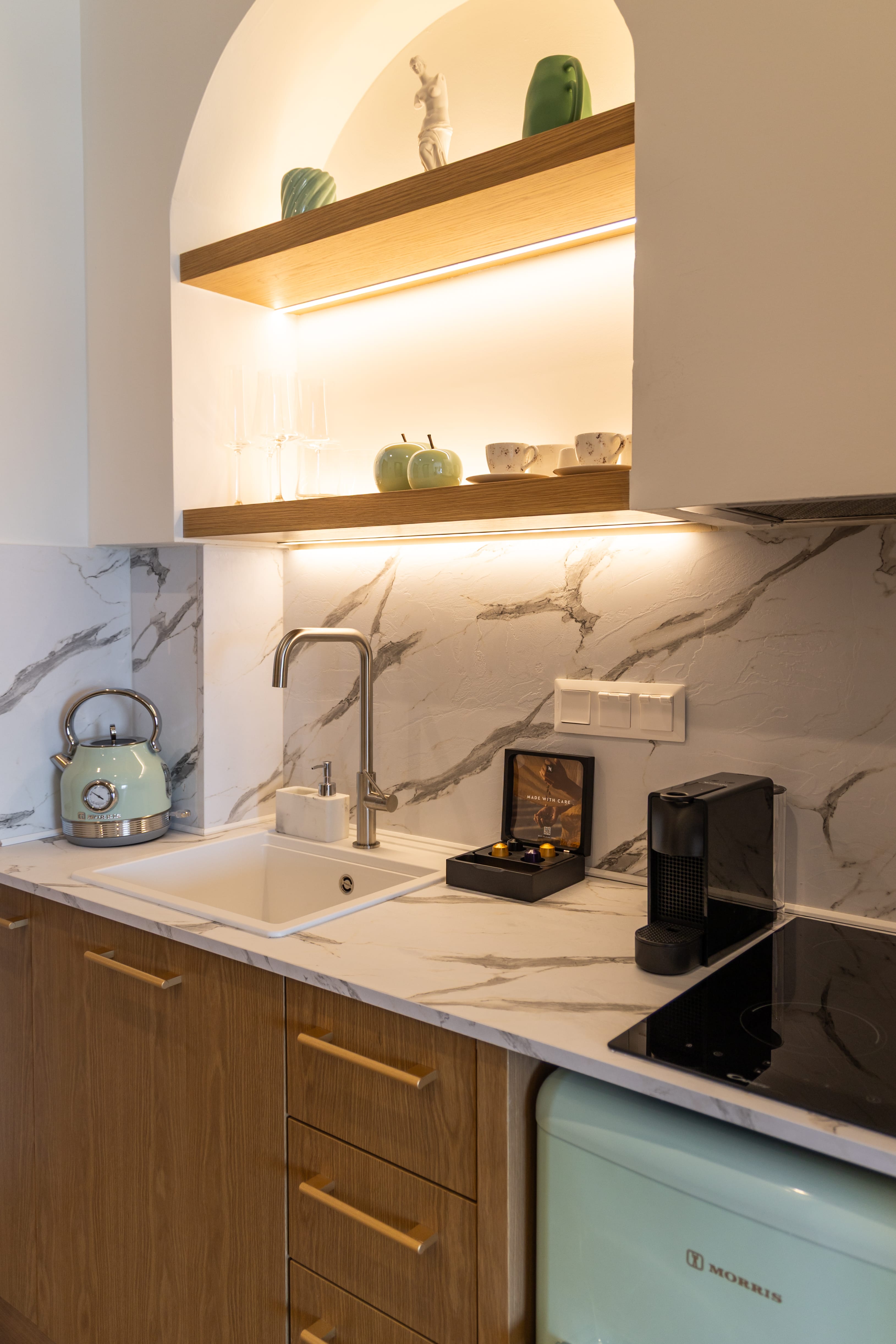 a kitchen with a mirror above the sink
