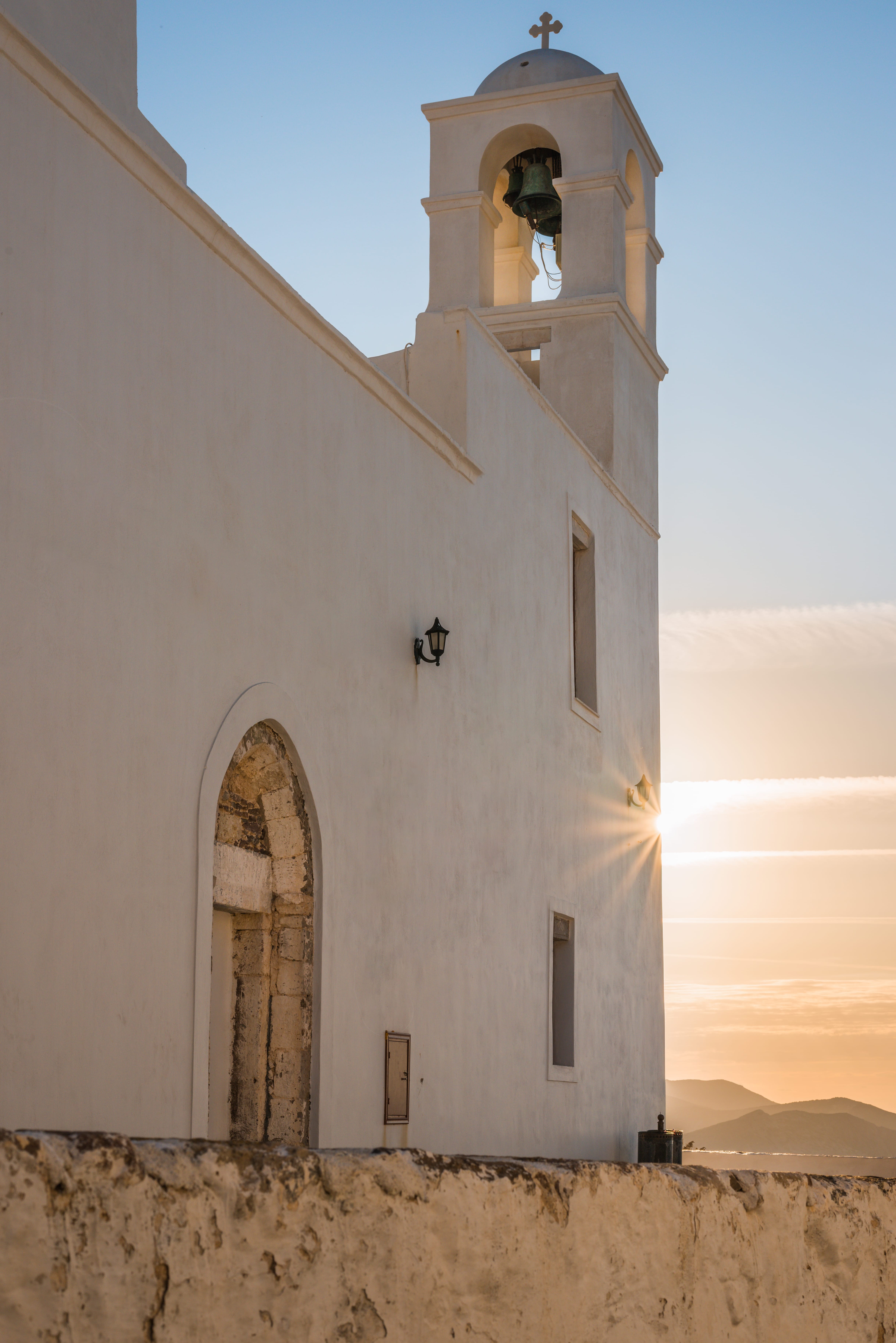 a white building with a bell tower