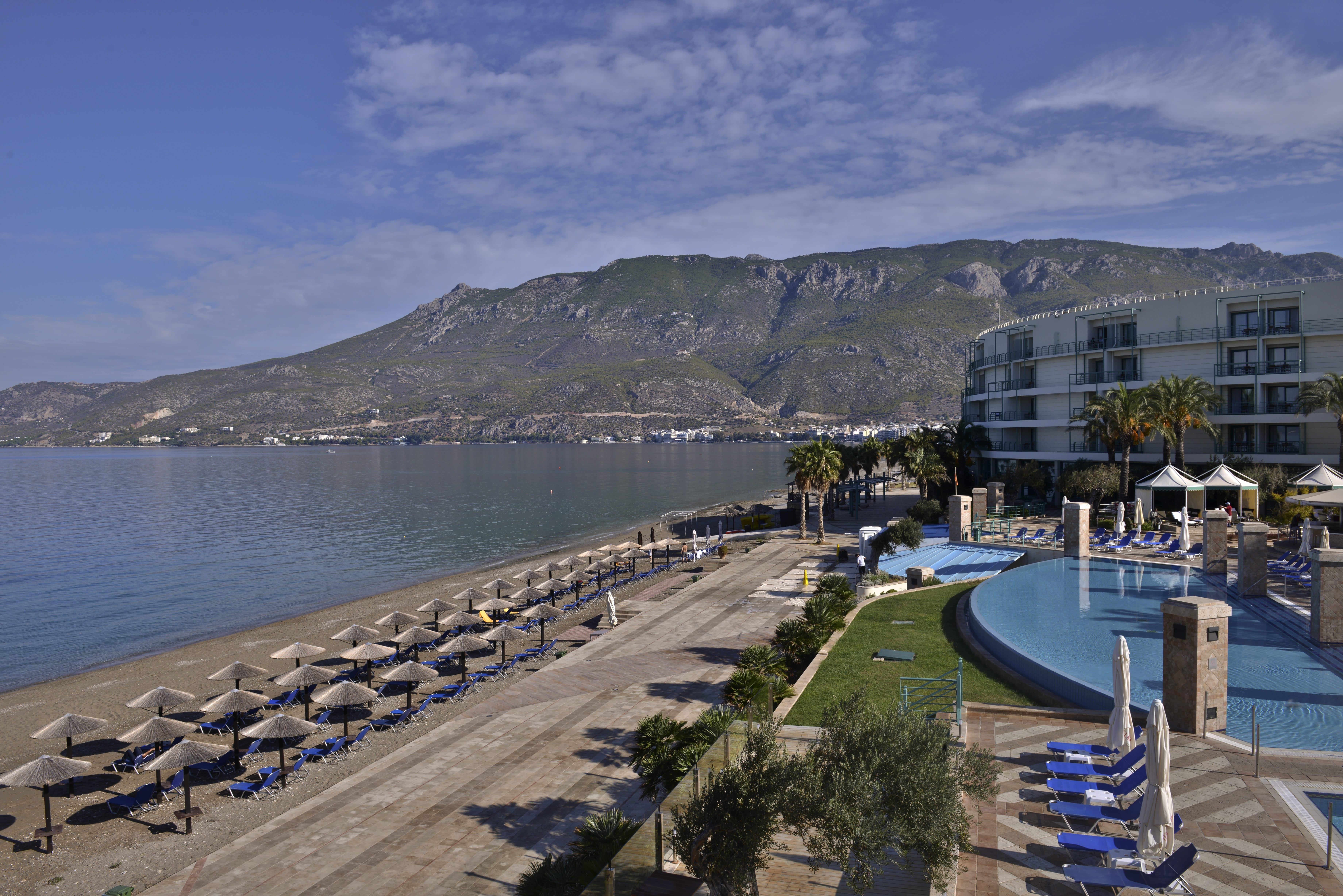 a resort with a pool and a mountain in the background