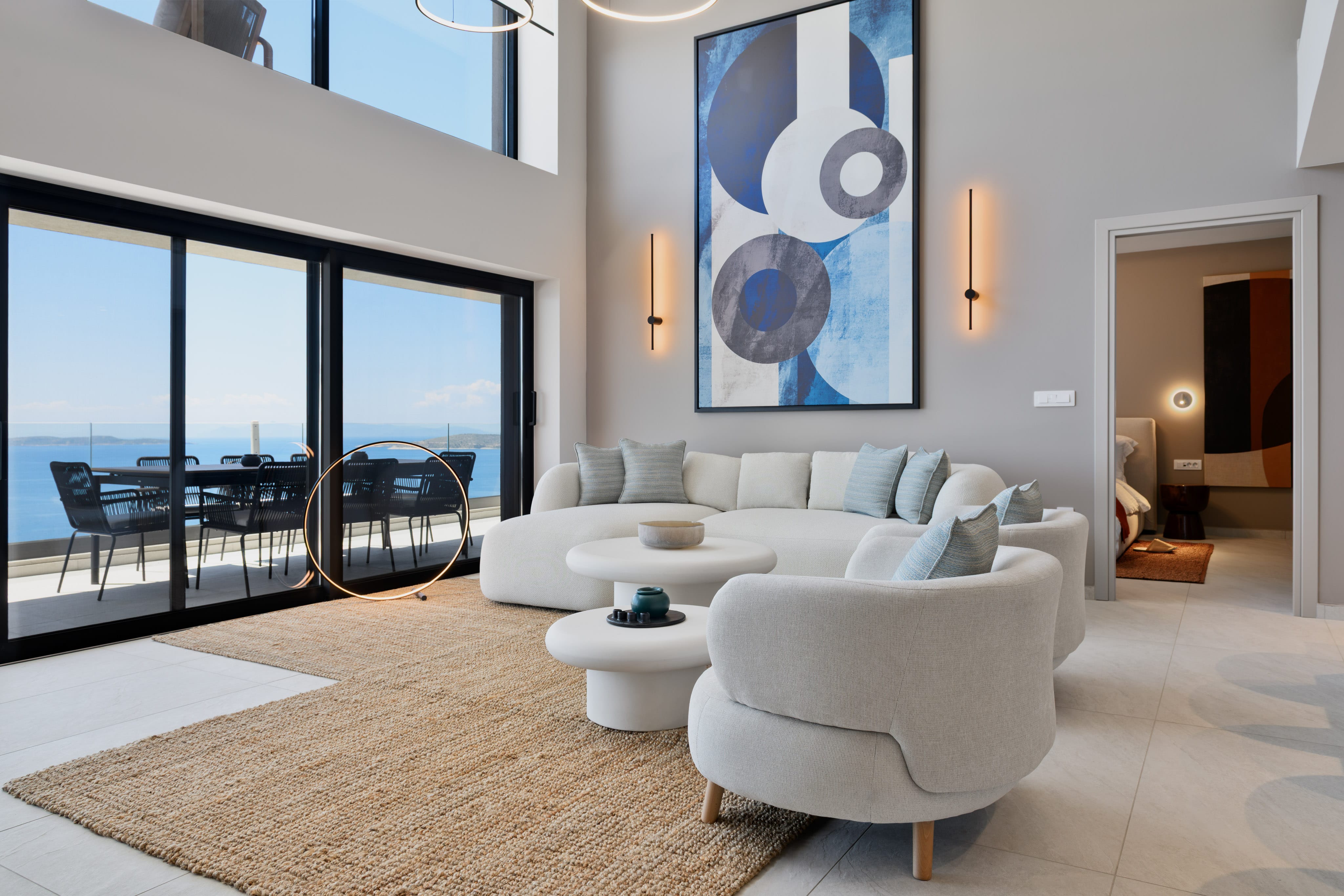 a living room with a large couch and a large glass door