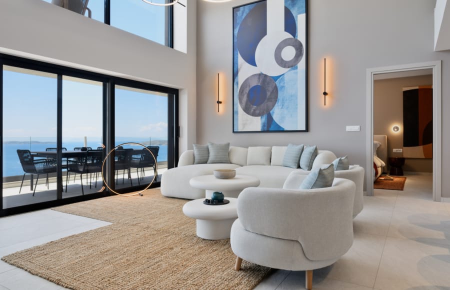 a living room with a large couch and a large glass door