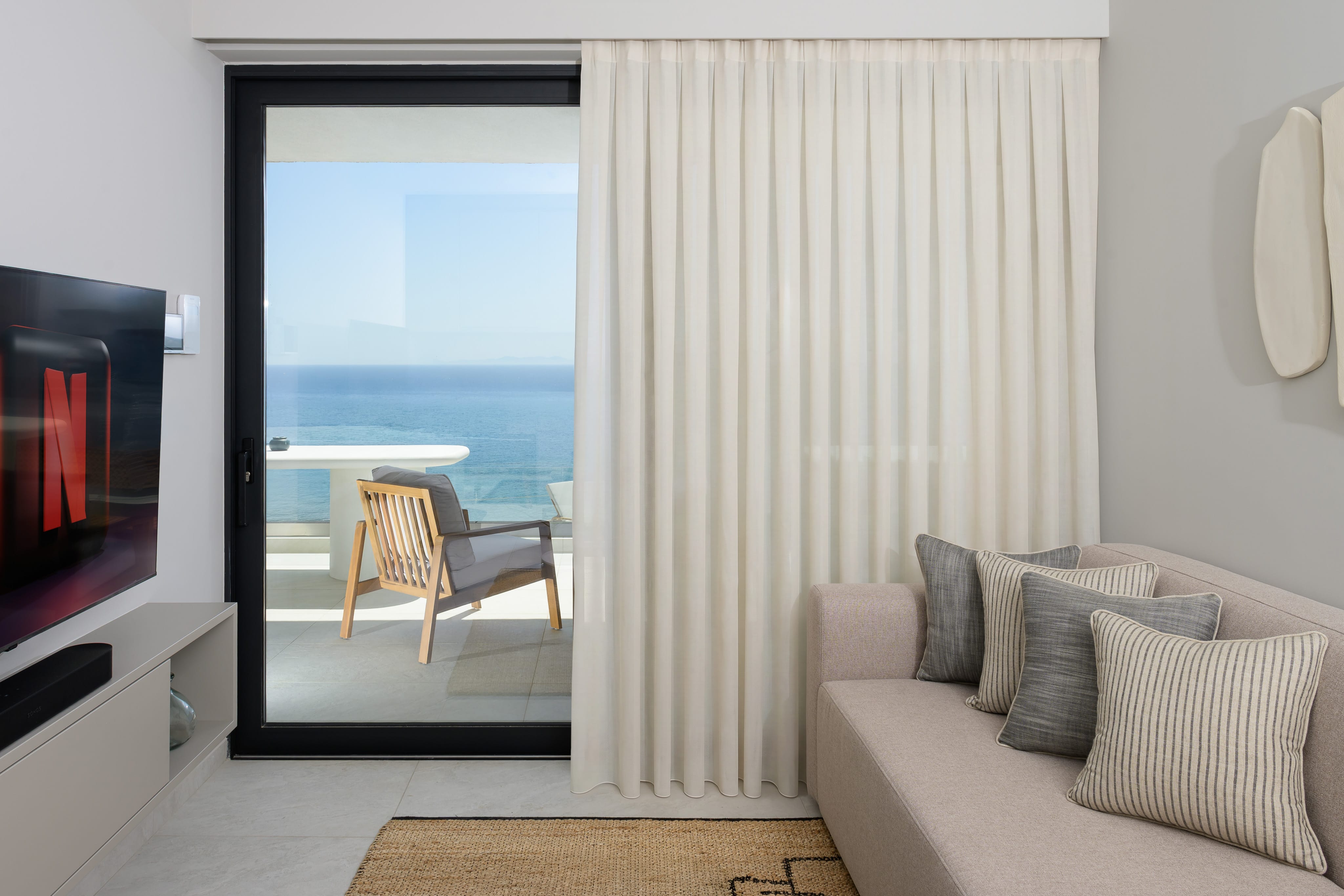a living room with a couch and a glass door