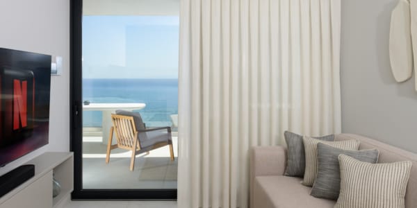 a living room with a couch and a glass door