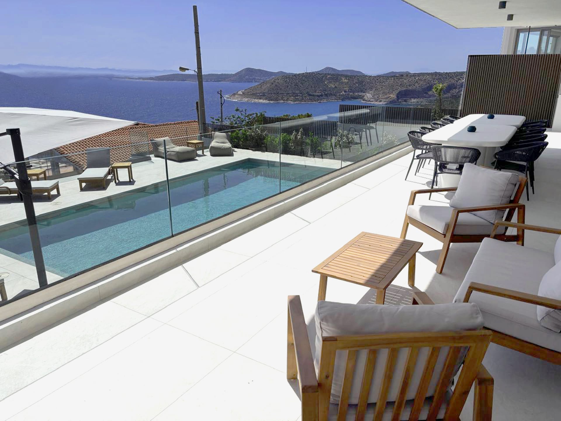 a deck with chairs and a pool
