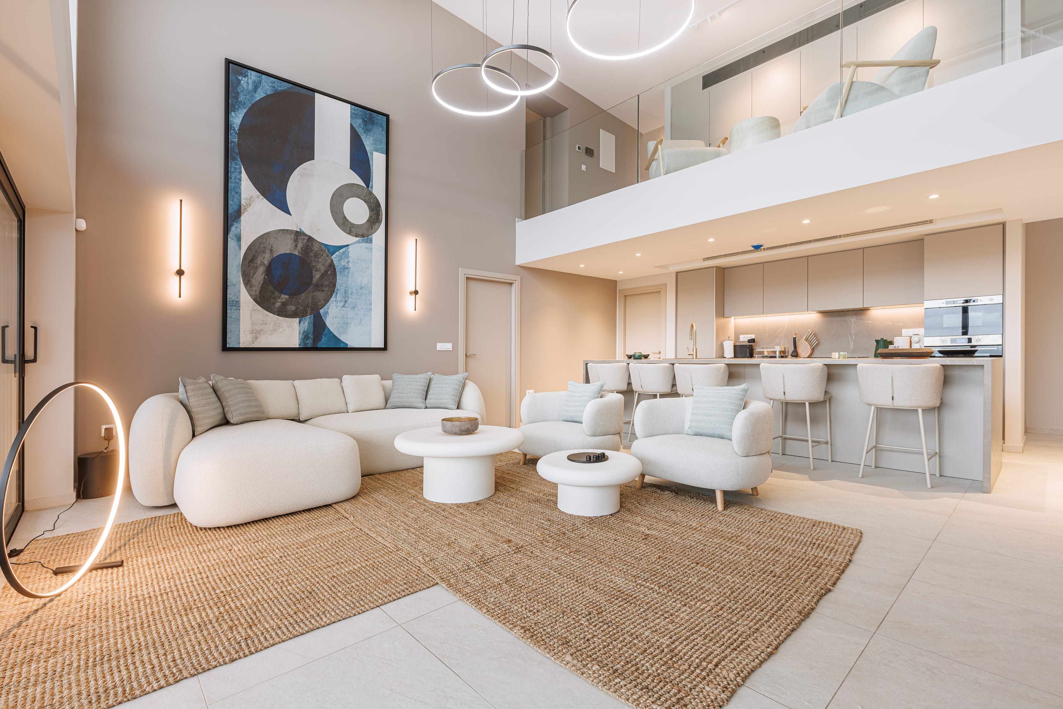 a room with a couch and chairs
