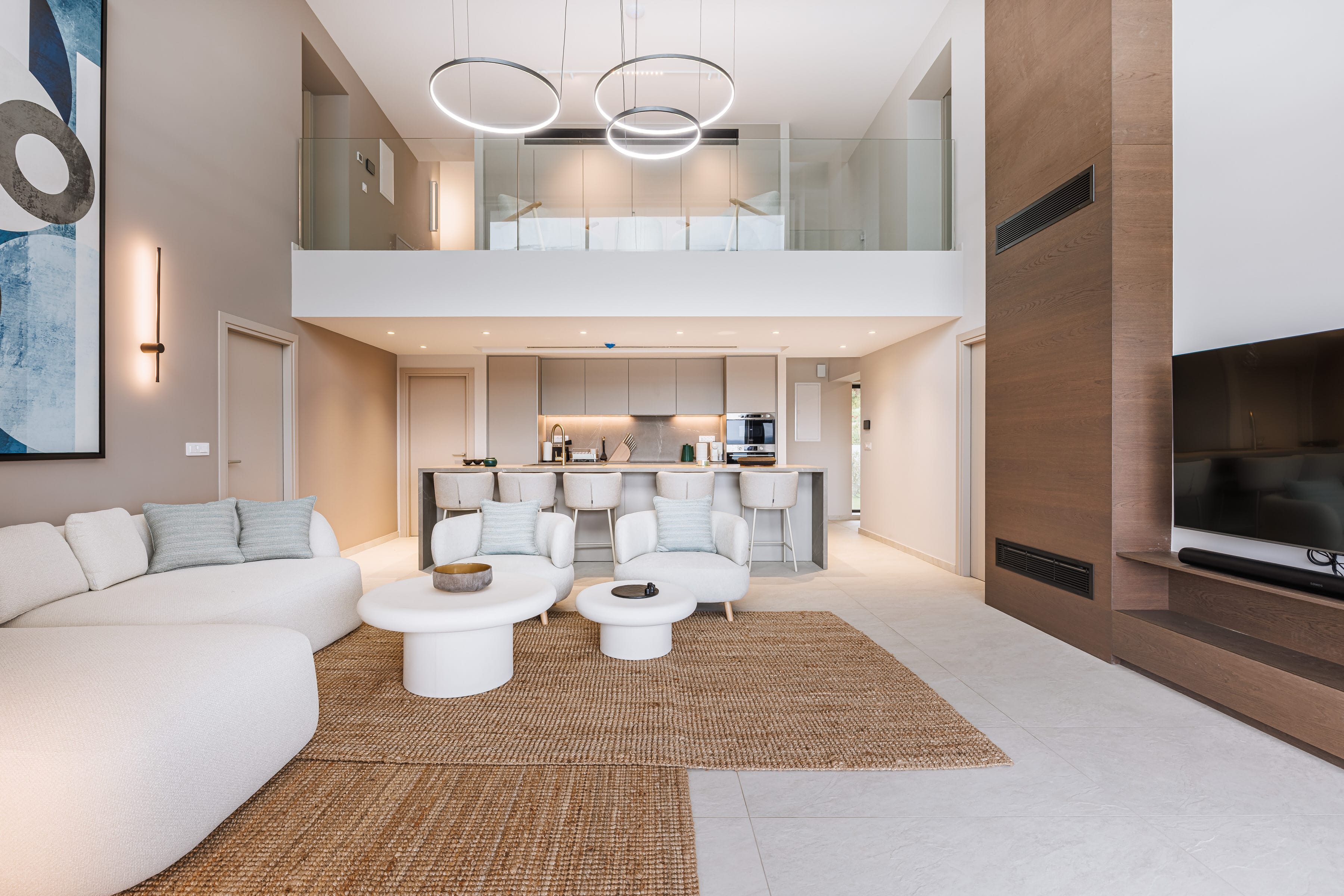 a living room with a large white couch and a white table