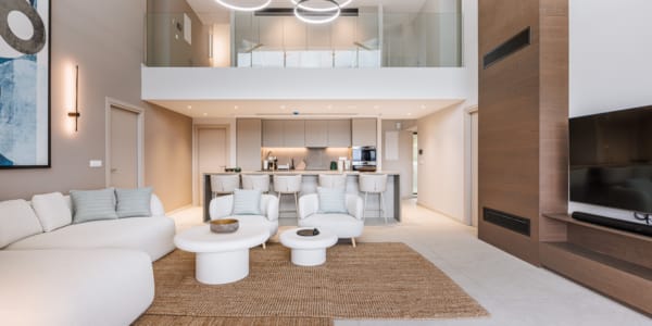 a living room with a large white couch and a white table