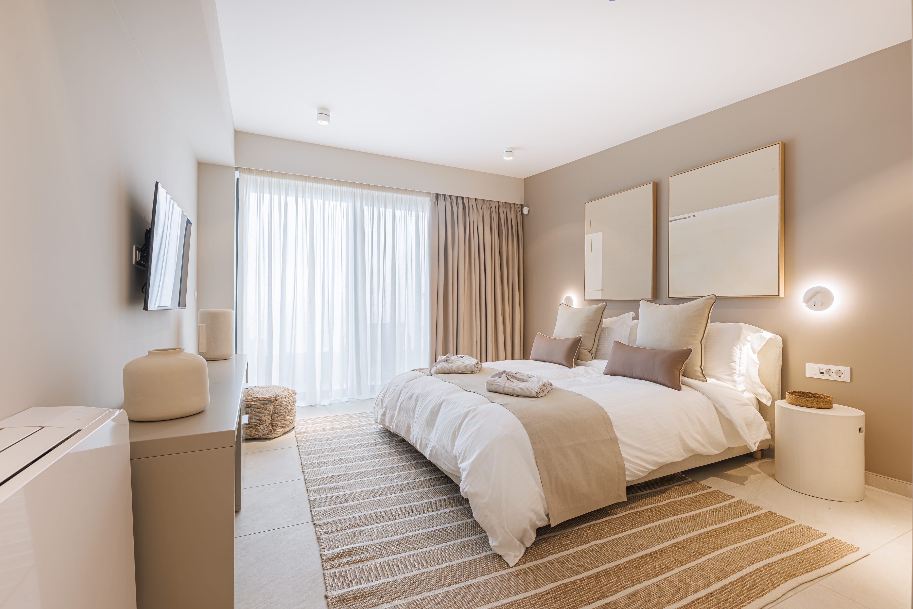 a bedroom with a bed and a tv