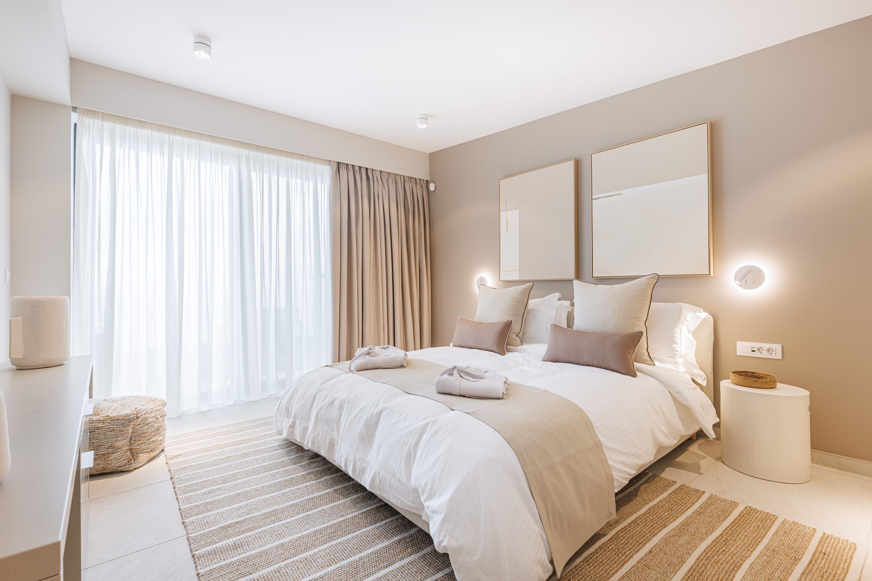 a bedroom with a bed and a large window