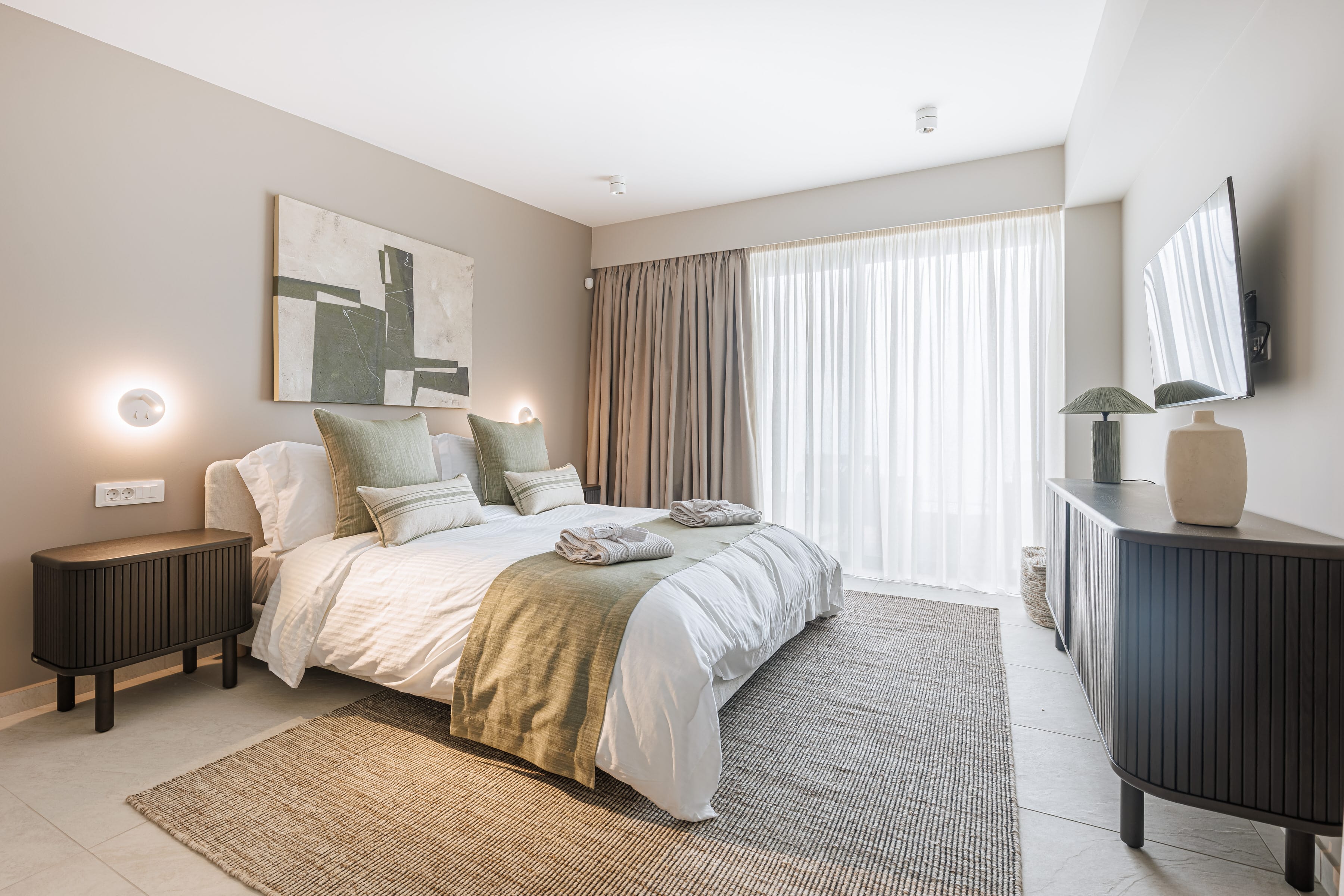 a bedroom with a bed and a tv