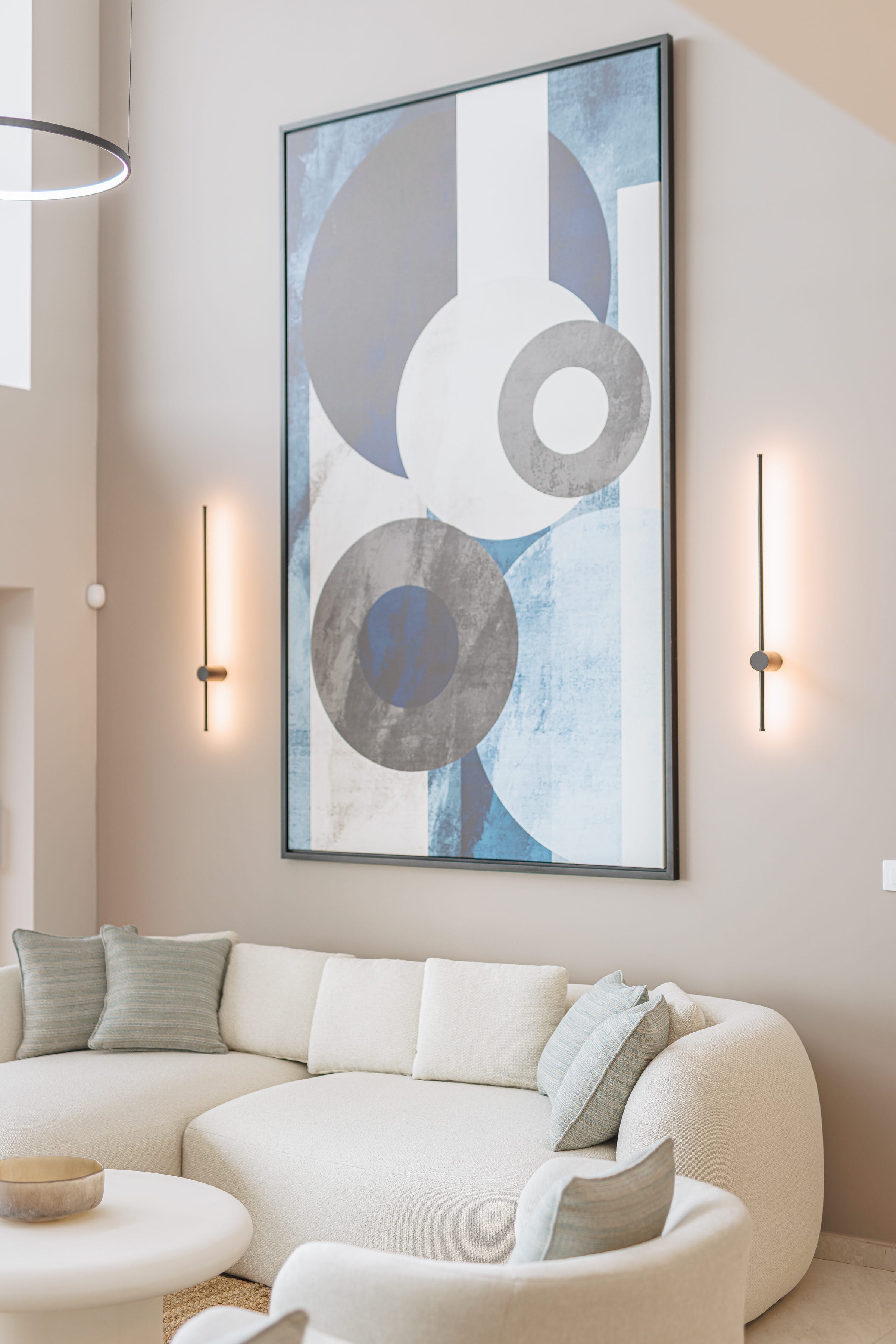 a white couch with a picture on the wall