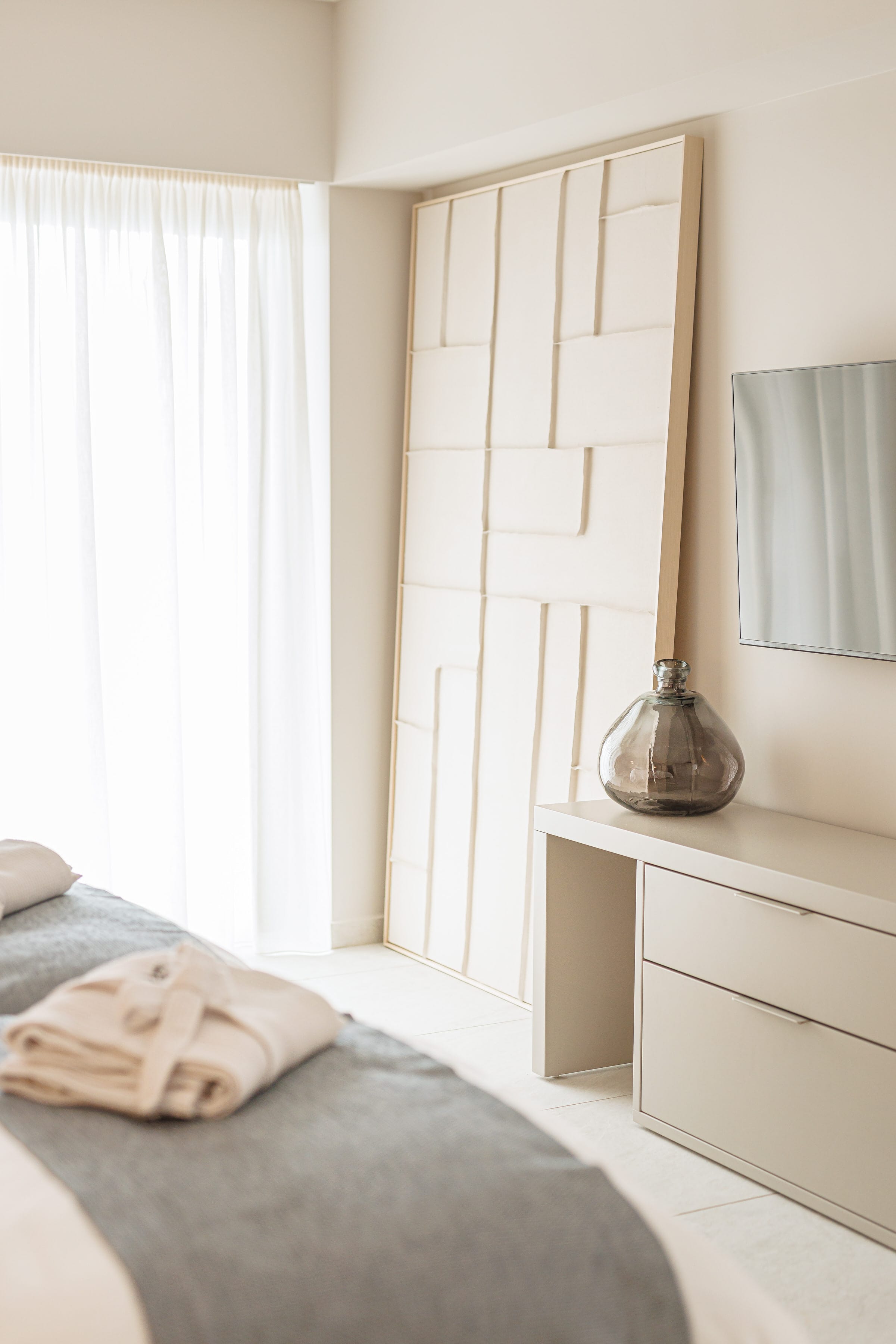a bedroom with a lamp and a mirror