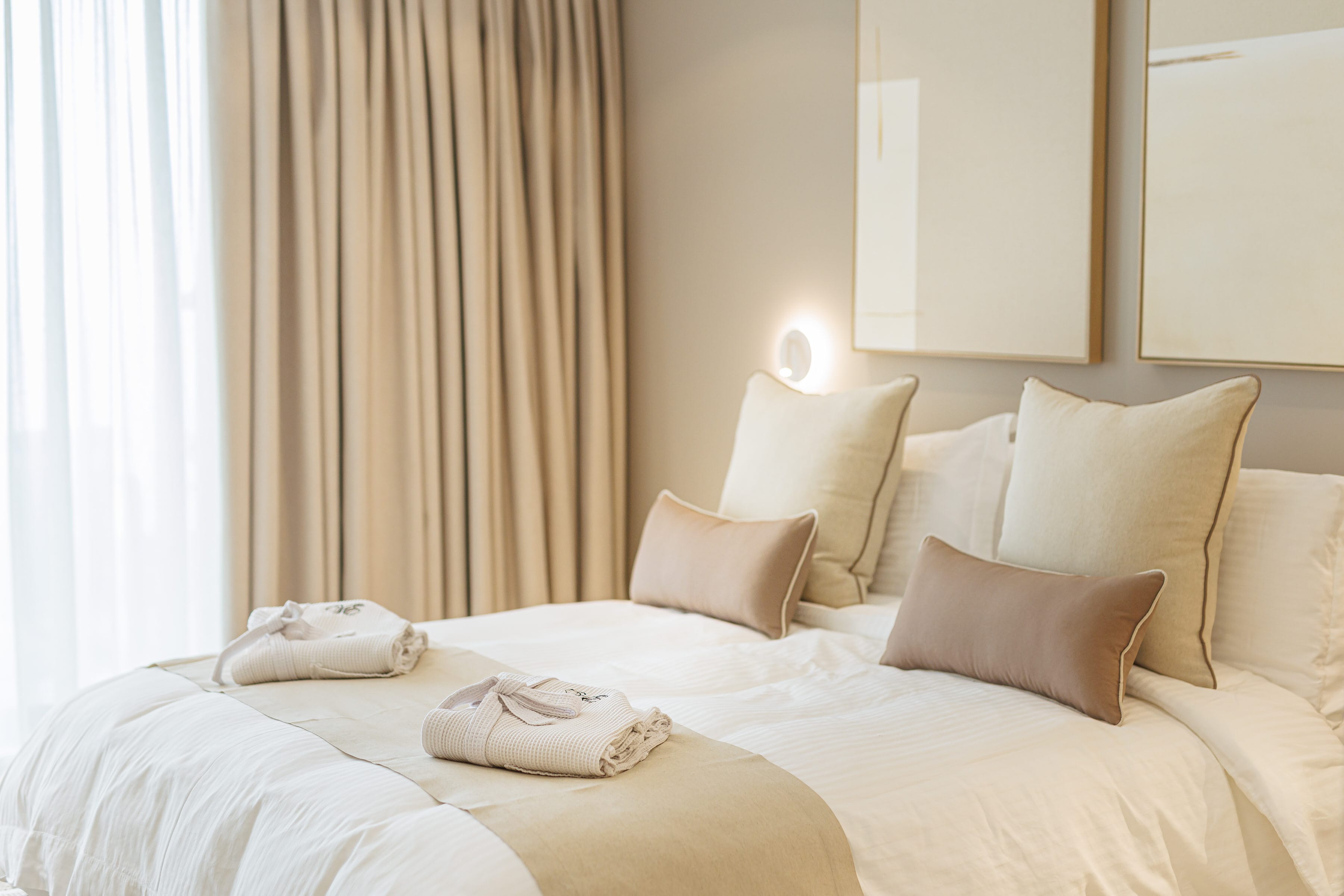 a bed with pillows and towels