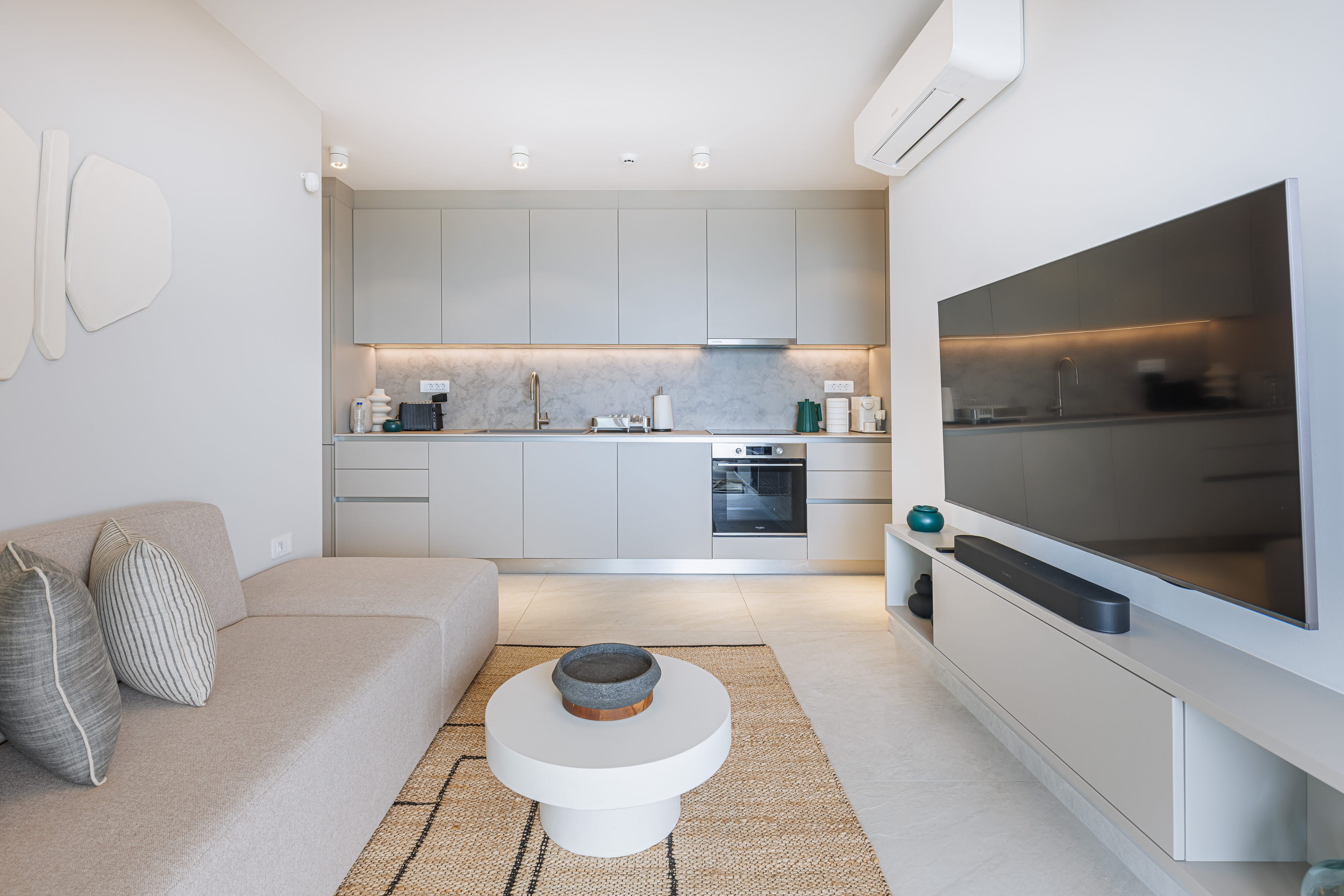 a living room with white cabinets
