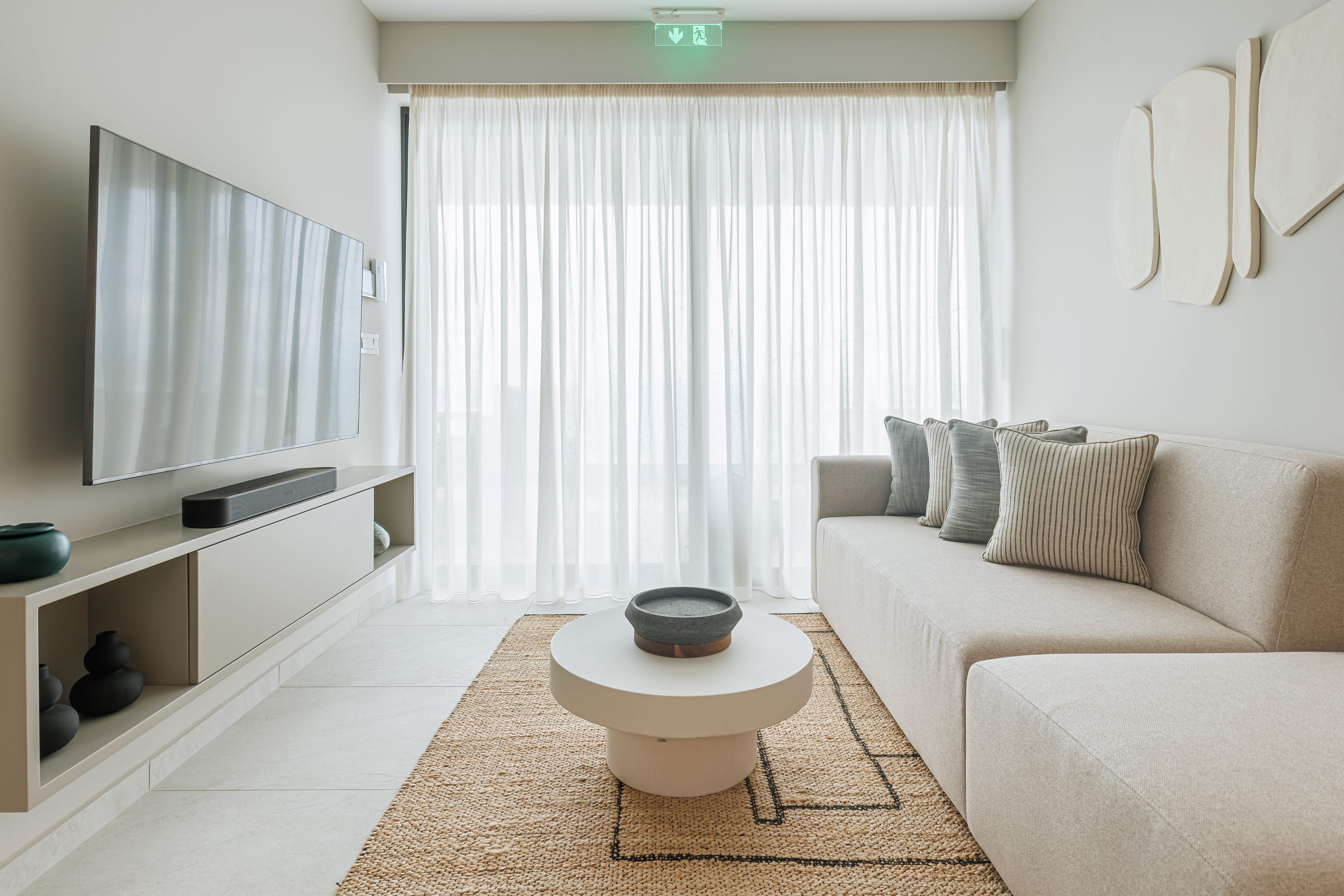 a living room with a white couch and a white table