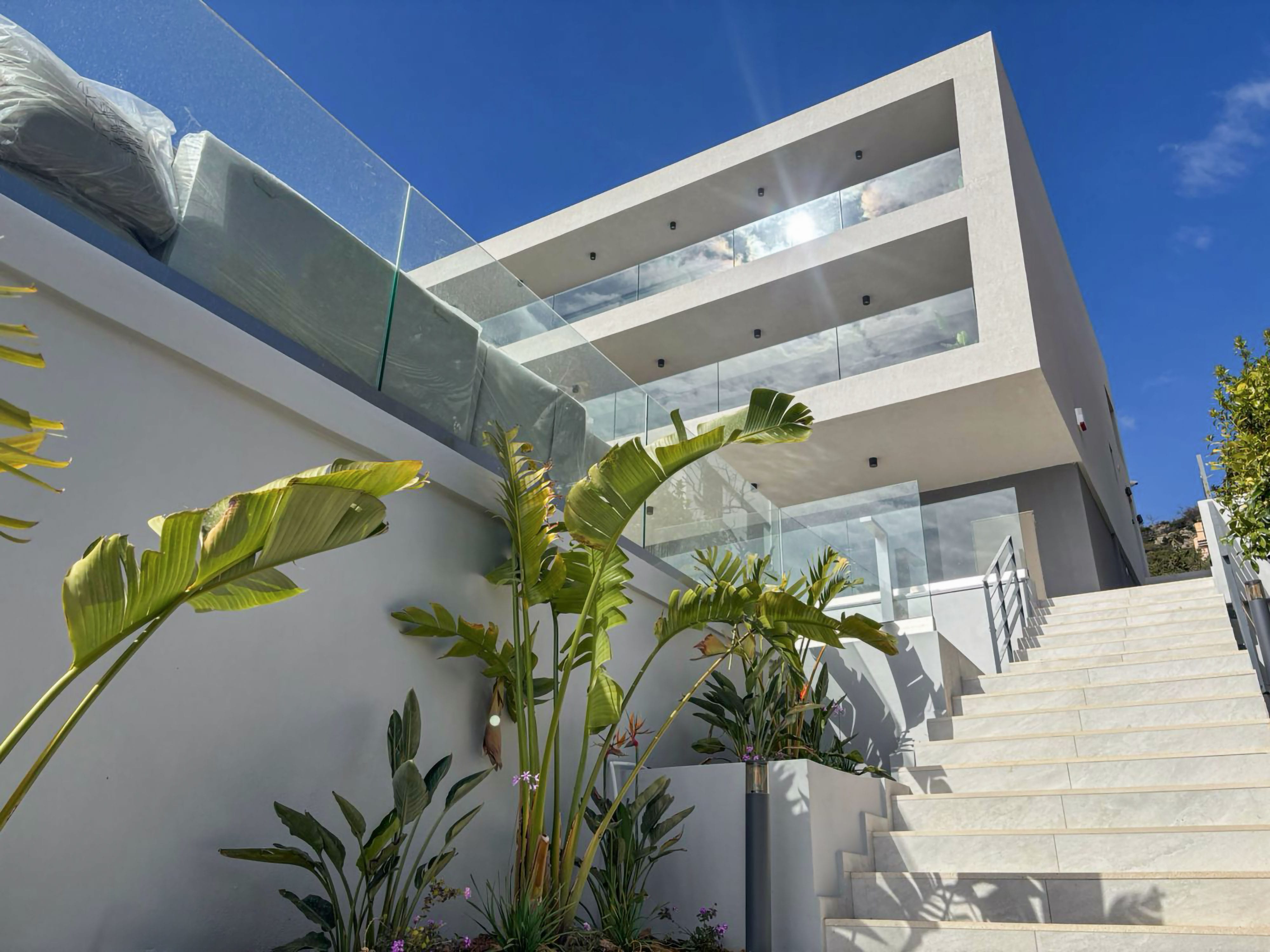 a building with a staircase and plants