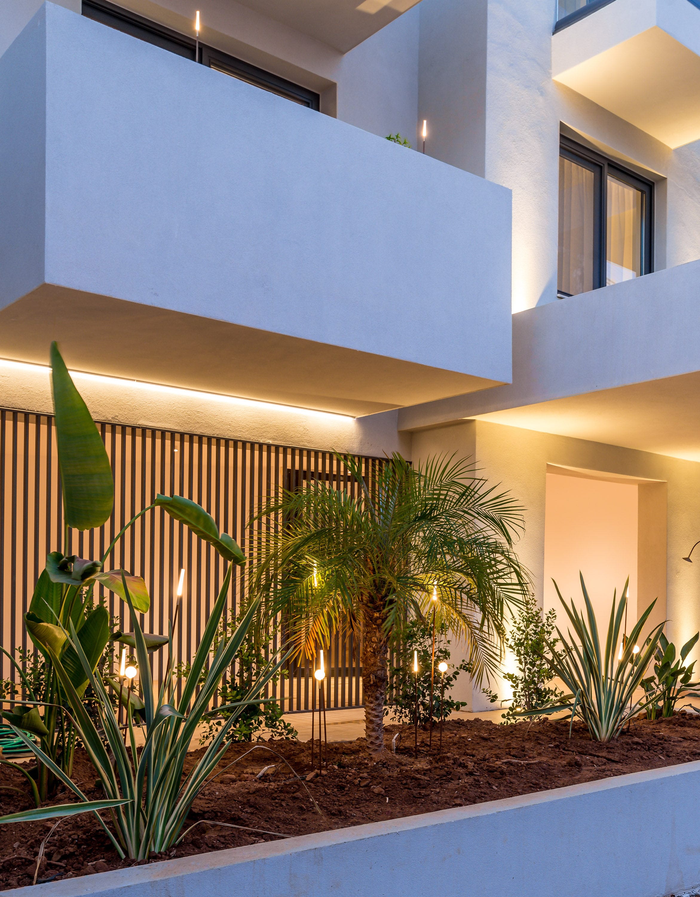 a building with plants and a pool