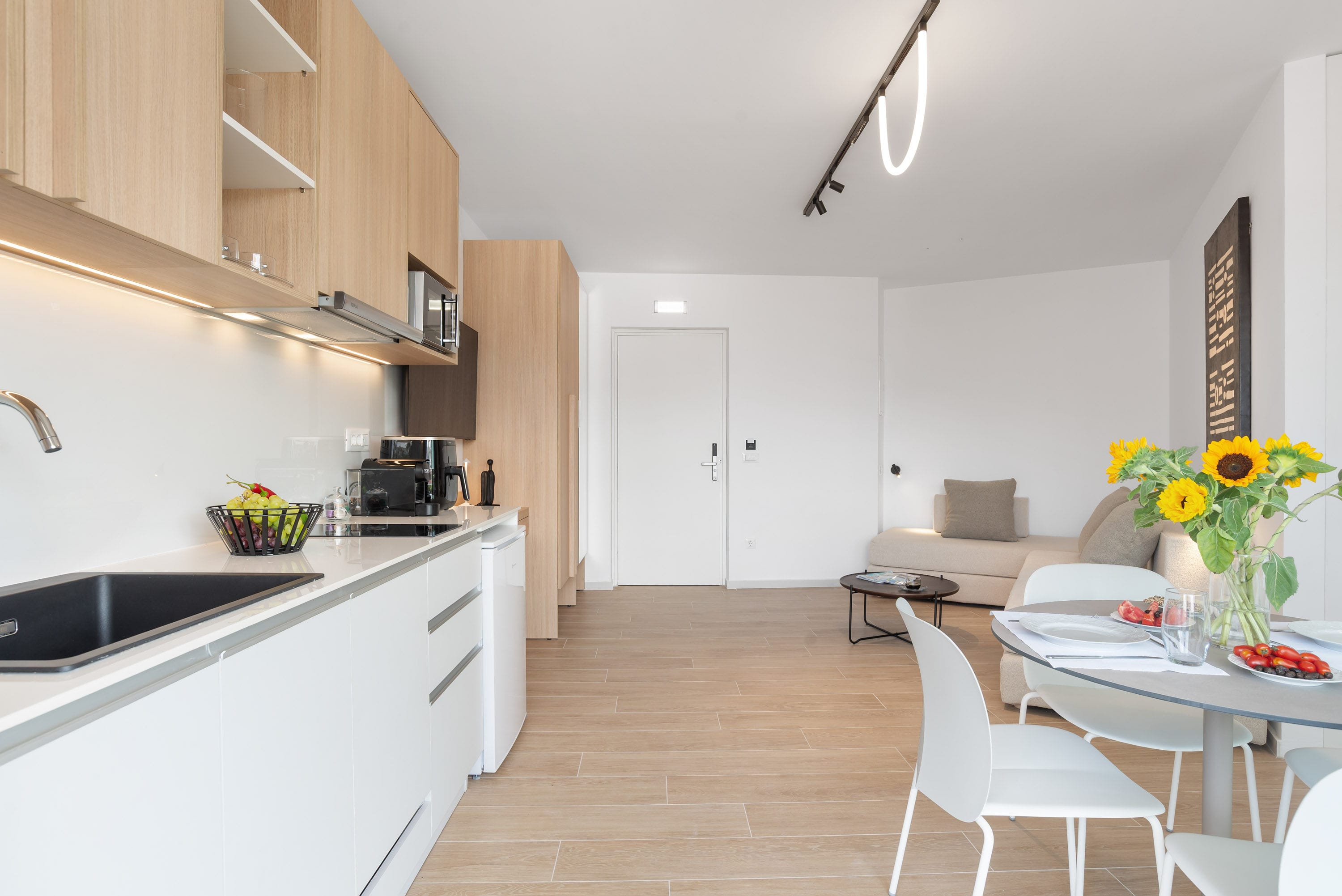 a kitchen with a dining table and white cabinets