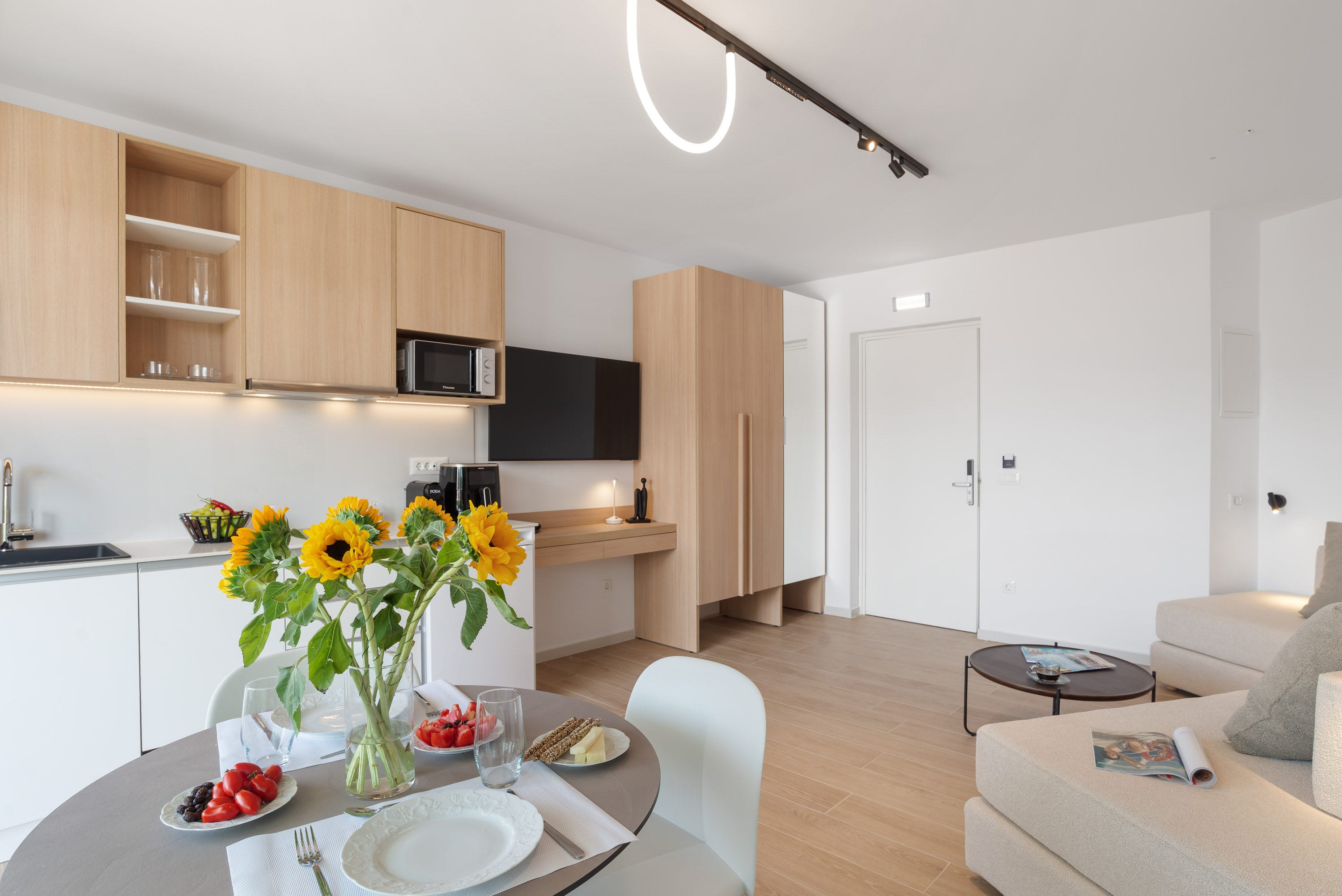 a kitchen with a dining table and a large white cabinet