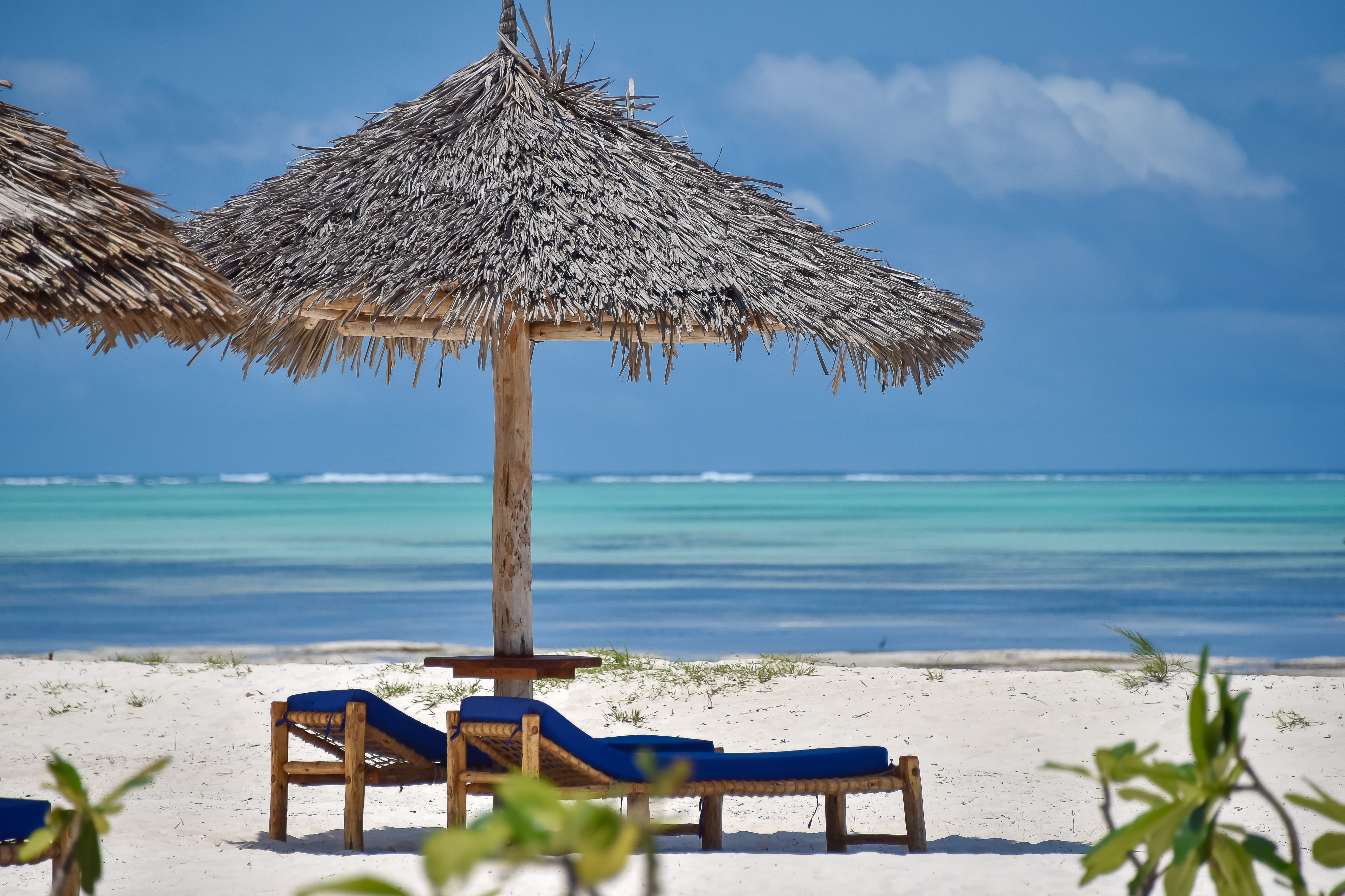 a straw umbrella on a beach