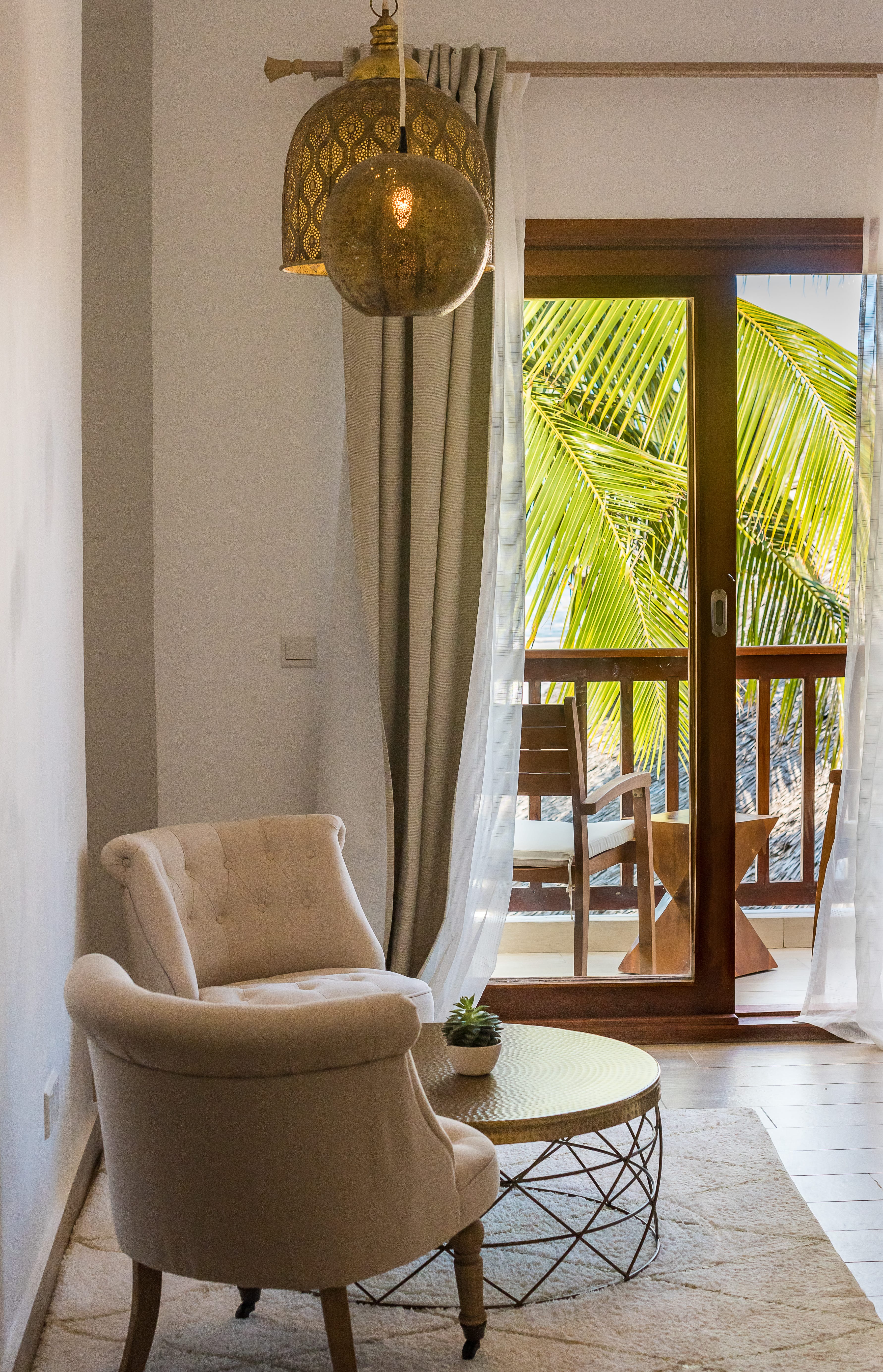 a room with a chair and a table with a lamp on it