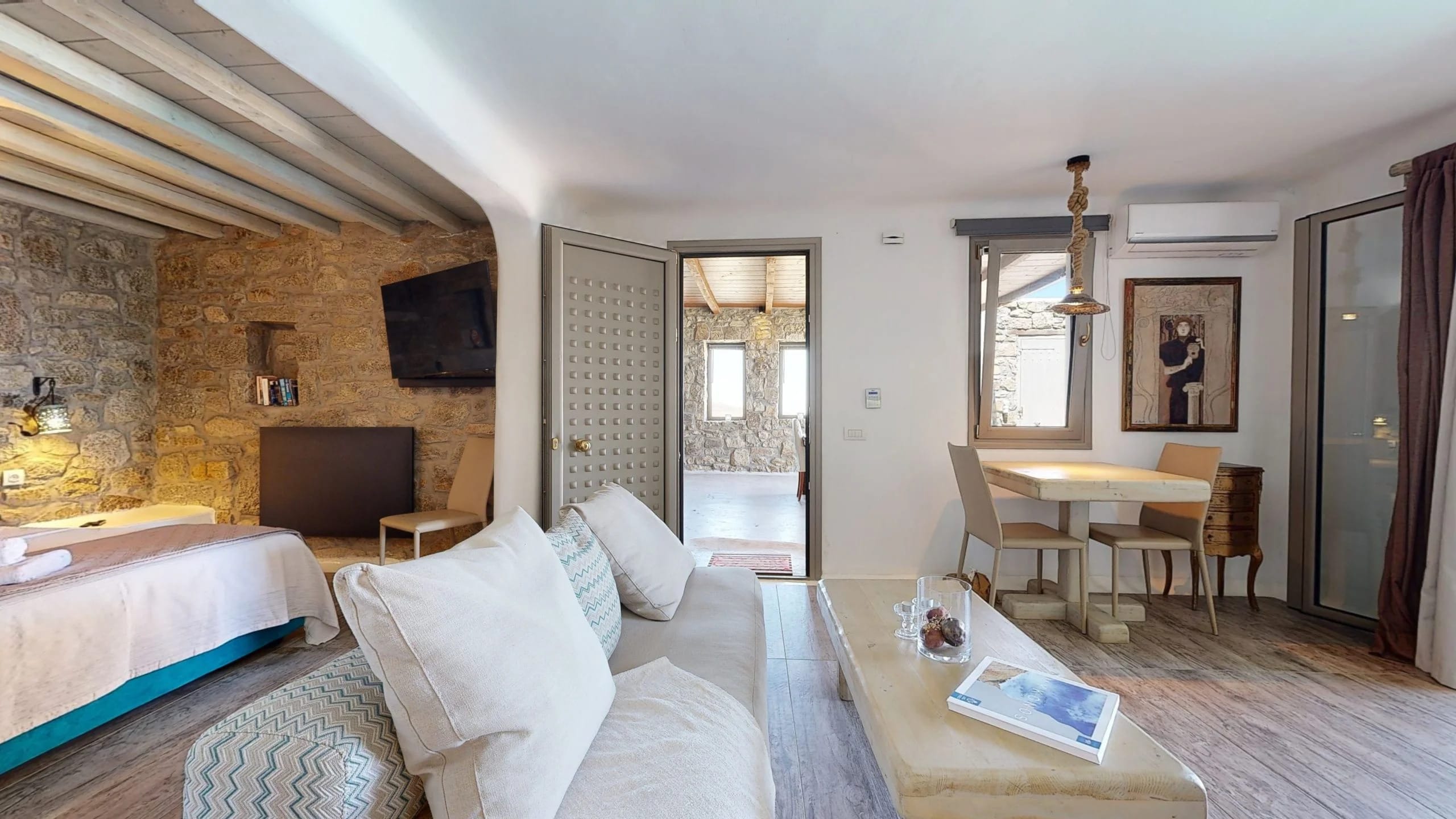 a large living room with a bed and a table