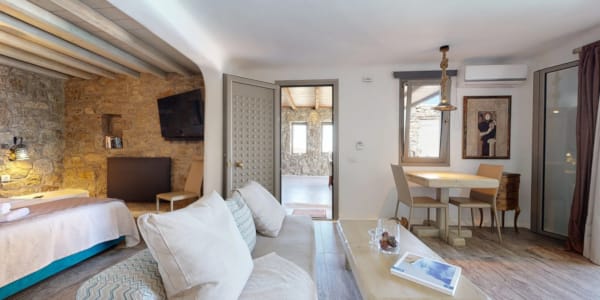 a large living room with a bed and a table