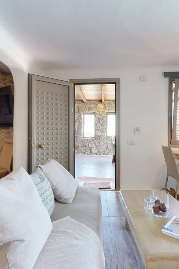 a large living room with a bed and a table