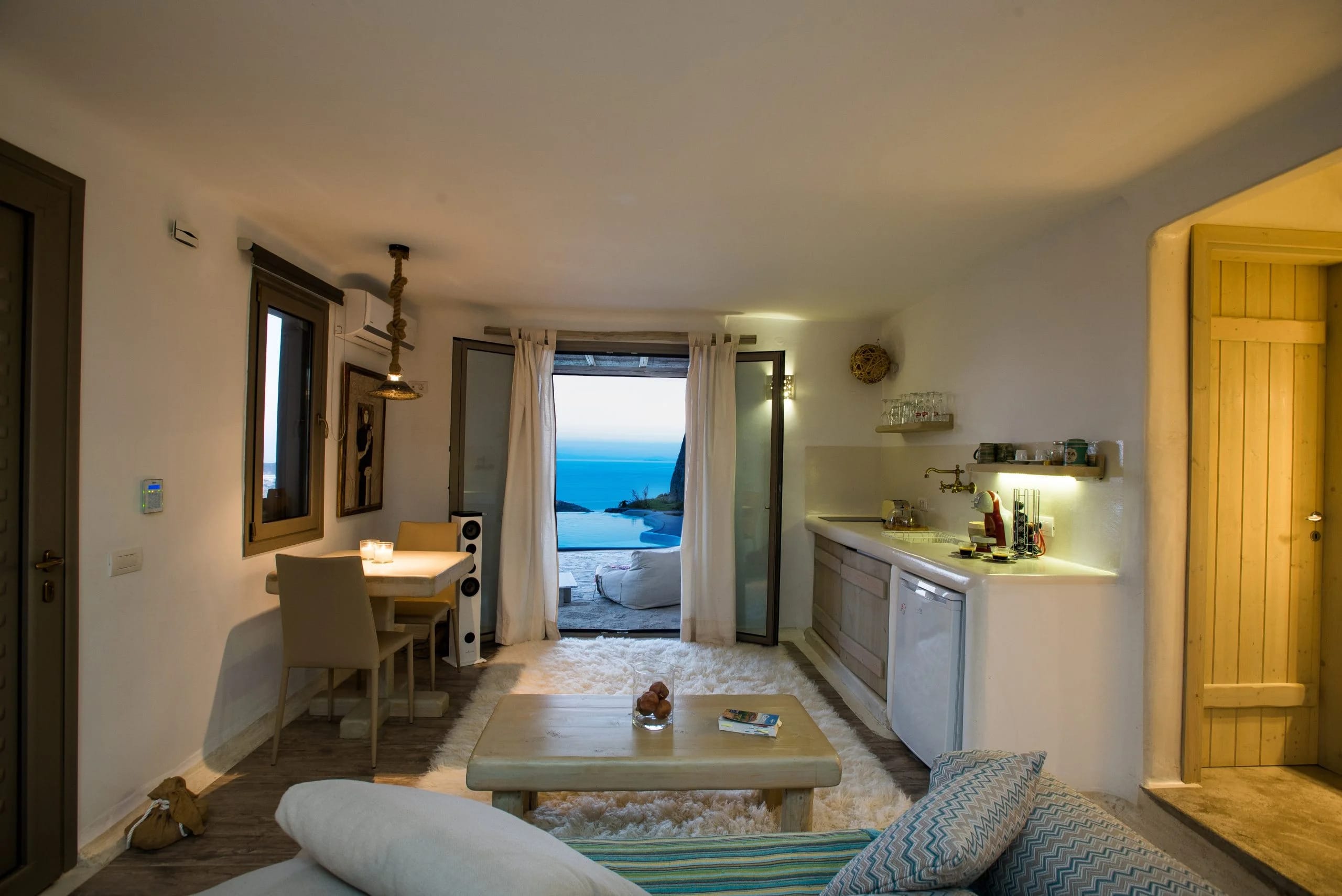 a living room with a view of the ocean