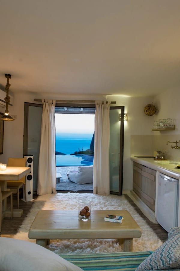 a living room with a view of the ocean