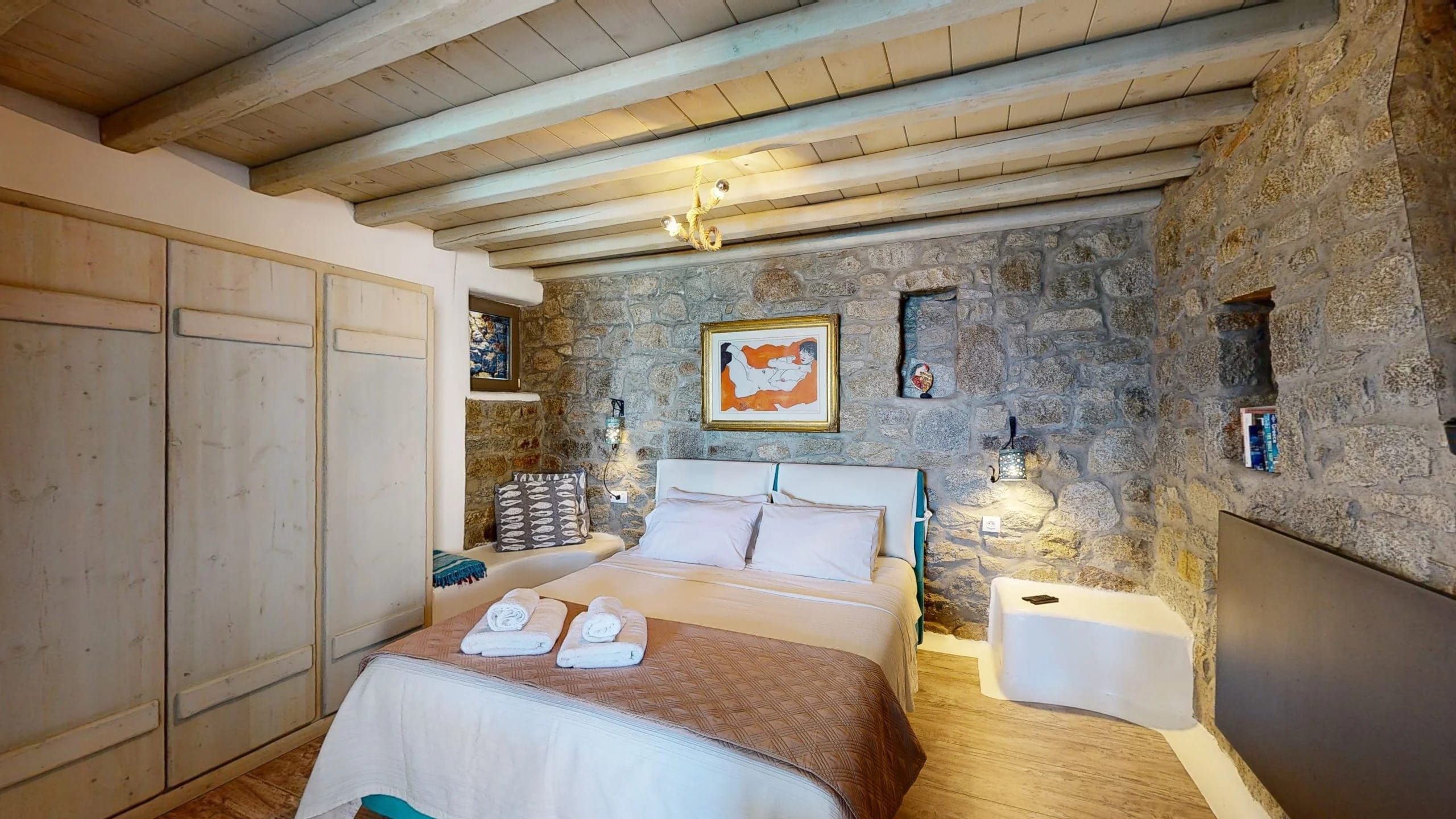 a bedroom with a bed and a bench