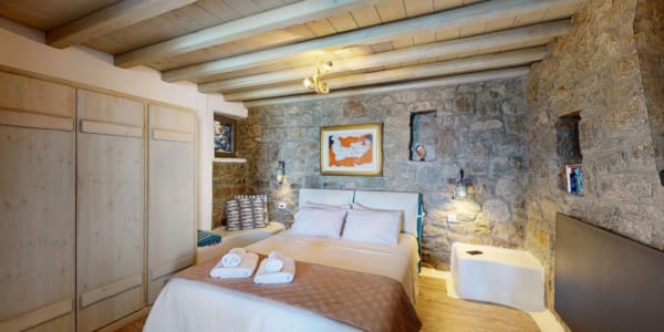 a bedroom with a bed and a bench