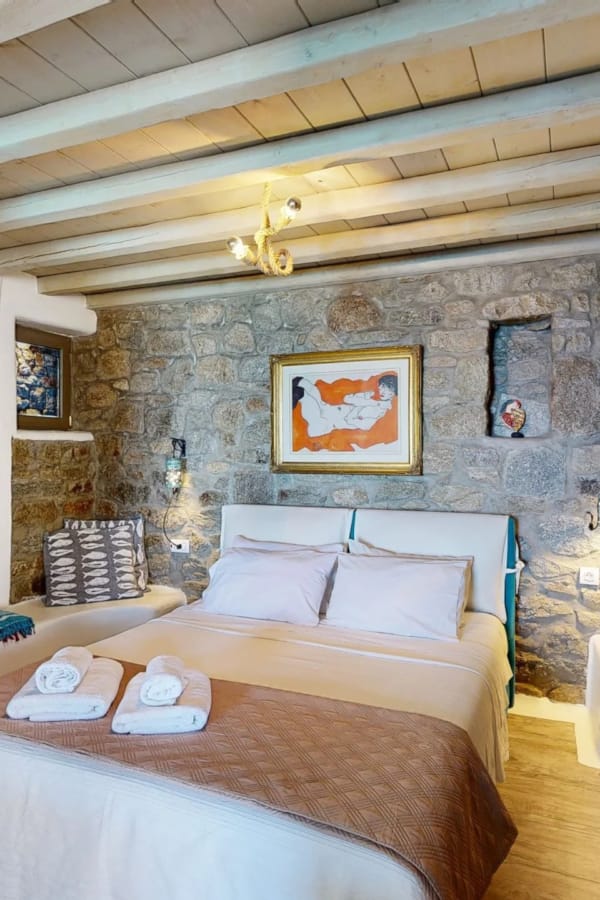 a bedroom with a bed and a bench