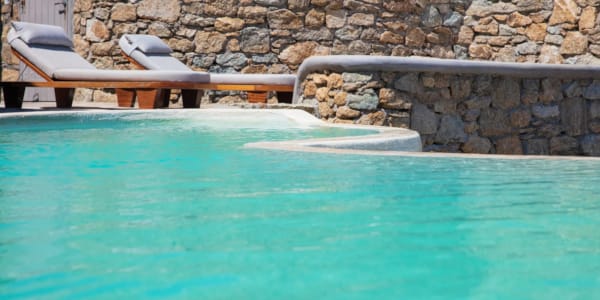 a pool with chairs and a table