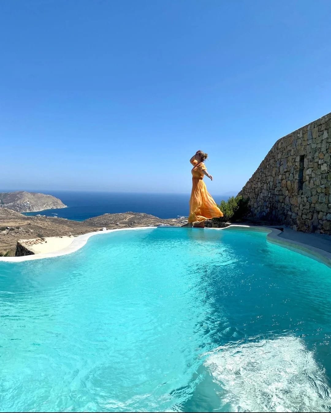 a person in a dress standing in a pool of water