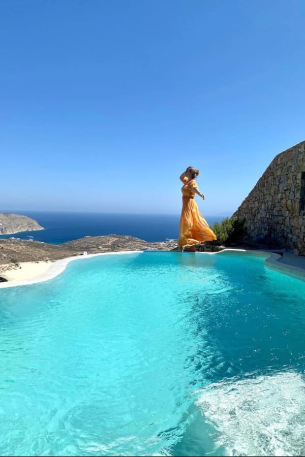 a person in a dress standing in a pool of water