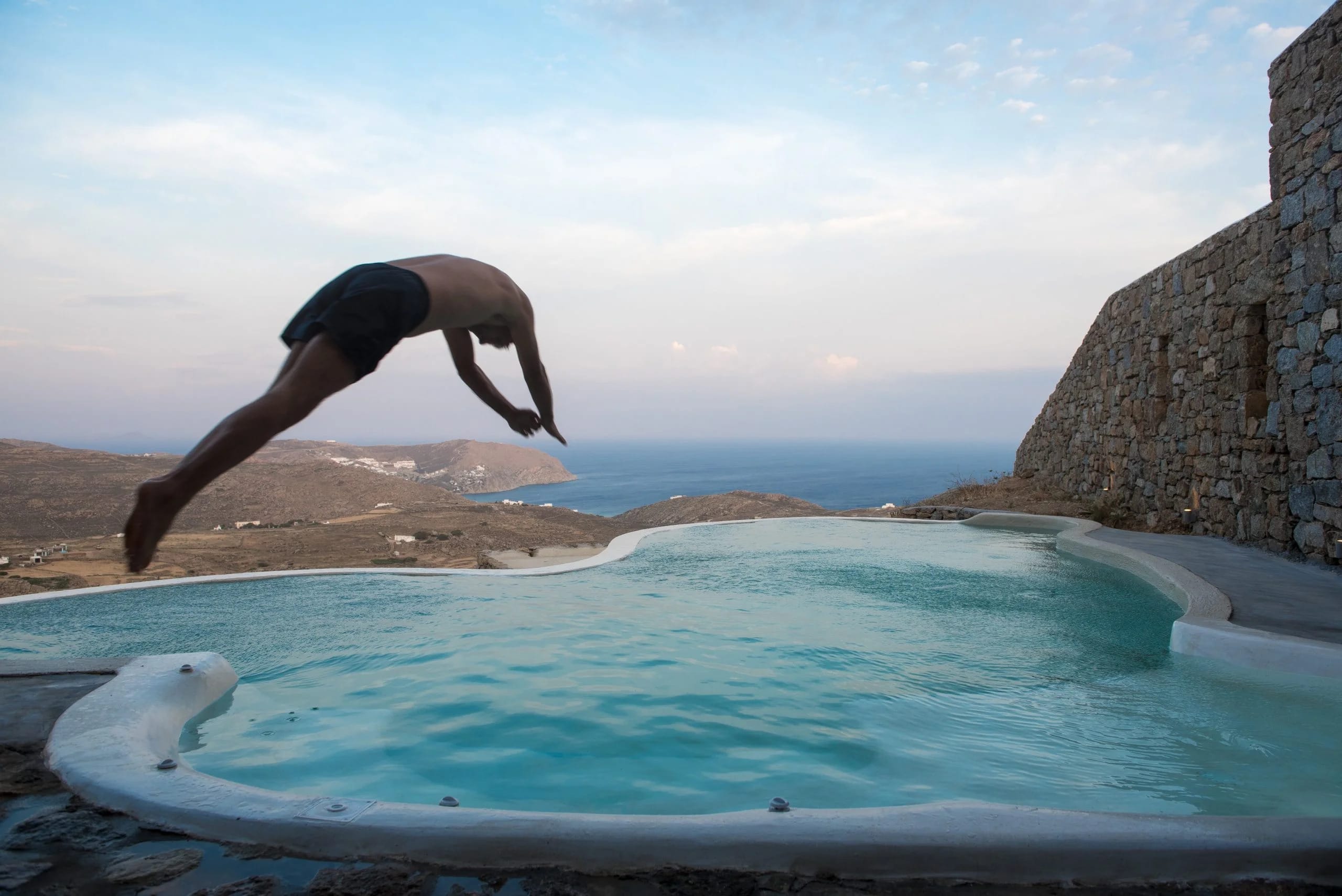 a man jumping into a pool